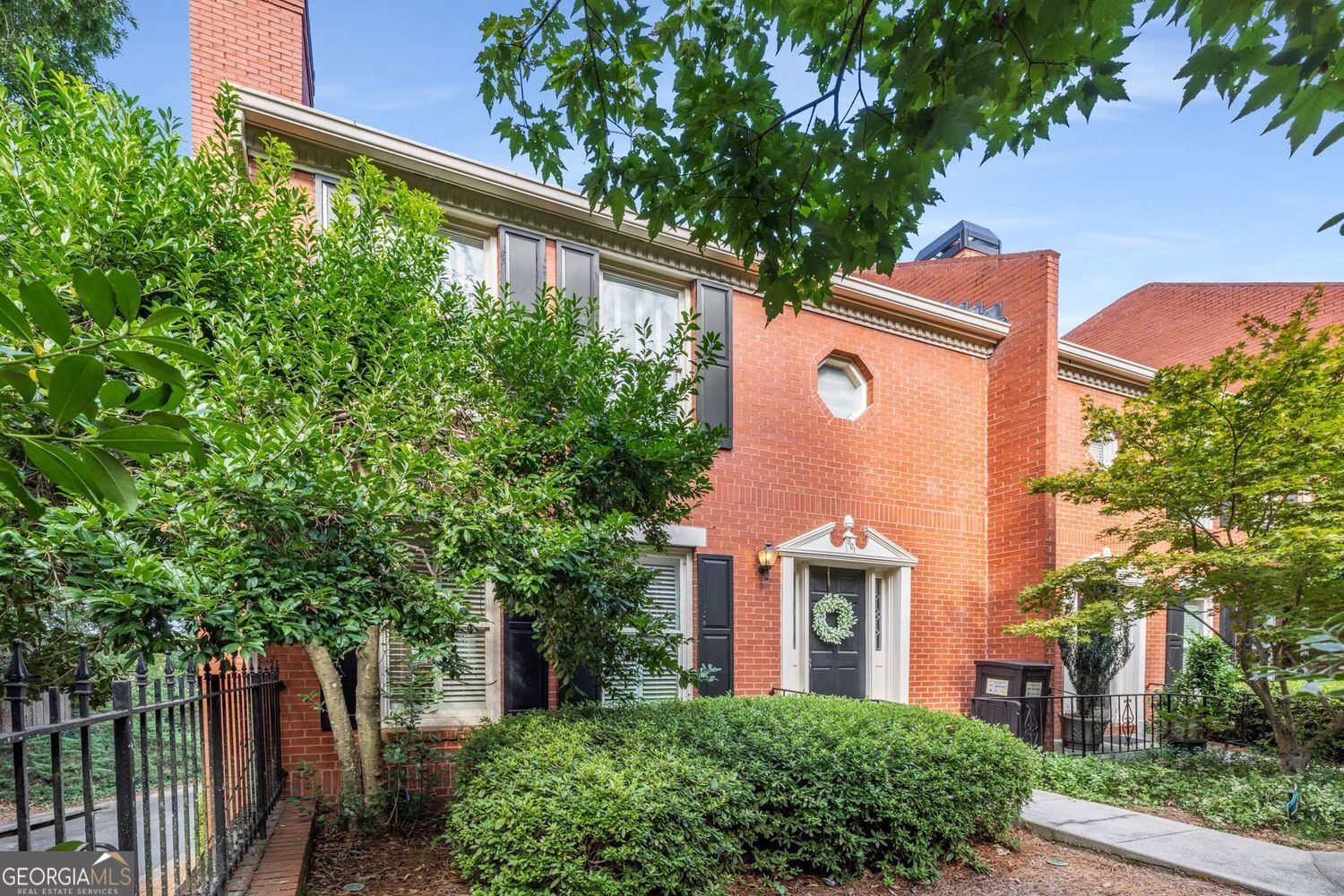 This strikingly remodeled and updated brick end unit townhome is ideally located on the vibrant Westside. Within Morris Brandon Elementary school and situated in a small, well-kept community with ample guest parking, this 3-bedroom, 2.5-bath residence combines timeless style with modern upgrades. The fully updated kitchen is a standout, featuring new appliances, custom countertops, and a gourmet coffee and beverage bar-perfect for both daily living and entertaining. Refinished hardwood floors flow throughout, leading to a private back deck for outdoor enjoyment. The spacious primary suite includes a walk-in closet and a luxurious bath with a glass-enclosed shower. The finished basement provides a versatile bonus room that can be transformed into a theater, gym, or game room. Additional highlights include a two-car garage and thoughtful updates throughout. With easy access to I-75 and just minutes from West Midtown, Howell Mill, and Buckhead, you'll enjoy proximity to top dining destinations and shopping. This townhome is the perfect blend of convenience, comfort, and sophistication.