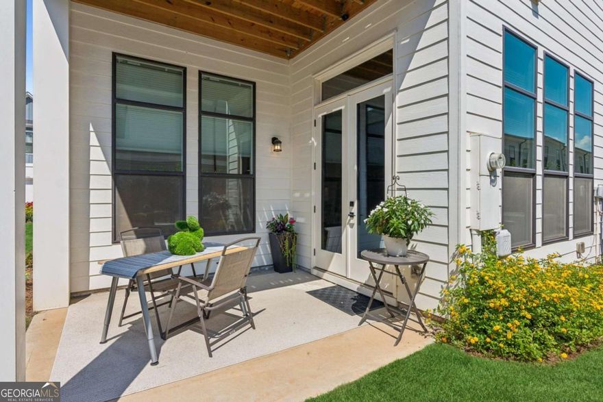 PRICE IMPROVEMENT to $529,000 3.13% ASSUMABLE RATE FOR QUALIFIED BUYERS! Seller Incentive $2,500 Any Way You Want It!  This immaculate 2021 Frisco by Davidson Homes offers a spacious open floor plan on the main level. The gourmet kitchen is perfect for entertaining with a large central quartz island. Stainless steel Kitchen Aid and Whirlpool appliances, high-speed vent-hood, recessed 5 burner gas stove-top, 42" soft close doors and drawers, quartz countertops and an oversized, double-door kitchen pantry with shelves all add to this beautiful home. The cosy living area features a linear electric fireplace, and hardwood floors are in the living areas with ceramic tile in all bathrooms. The homes boasts 11ft ceilings on the main floor, 10ft ceilings on upper floors and 8ft interior doors throughout. Oak-tread stairs with high grade carpet lead up to three carpeted bedrooms and the laundry room with ceramic tile, custom cabinetry and a wash basin. The generous primary bedroom suite has a large shower and double vanities, an oversized closet with 'Spacemaker' design built-ins, and off the primary suite is a private, covered deck with ceiling fan, perfect for your morning coffee. Both additional bedrooms have ceiling fans and walk-in closets with shelving, and custom plantation shutters. Multiple upgrades to the home include: on-demand hot water heater (full home); garage shelving and storage; built-in whole-home Wi-Fi router/extender; custom window treatments throughout, including German-engineered ceramic tint on windows and doors (excluding dining room), motorized, remote-control shades in living and dining room, custom light filtering shades and custom blackout drapes in the primary bedroom. Dual zone HVAC unit with smart thermostats upstairs and downstairs, and custom under-stair security storage. The garage has a Wi-Fi -enabled Smart garage door system and the front and back of the home are landscaped. The upper deck and lower patio could be converted to a screened-in or enclosed porch and the back and side sod areas of the home can easily be enclosed for pets. The village at Towne Lake is not just a beautifully maintained gated community of fabulous homes and excellent amenities, it's a whole lifestyle! The HOA maintains the lawns and pine straw around the home and provides weekly maintenance for the community and home owners. Security 12pm-10pm 7 days a week. The gated community has 2 access entry/exit points. All neighborhood streets are planned to be repaved during 2025. An extensive neighborhood landscaping project was recently completed.  The elegant clubhouse has an indoor and outdoor fireplace, pool with tables/umbrellas, gym, pool table and kitchen area all of which can be reserved for private celebrations and gatherings for no additional fees (clean up only).Social events currently include monthly Saturday morning coffee/snacks, book club, and more. There is a large fire pit with seating to enjoy s'mores and socializing, 3 fenced dog parks with artificial turf. Walkable neighborhood with easy access to Woodstock Greenprints trail system and access to vibrant downtown Woodstock.