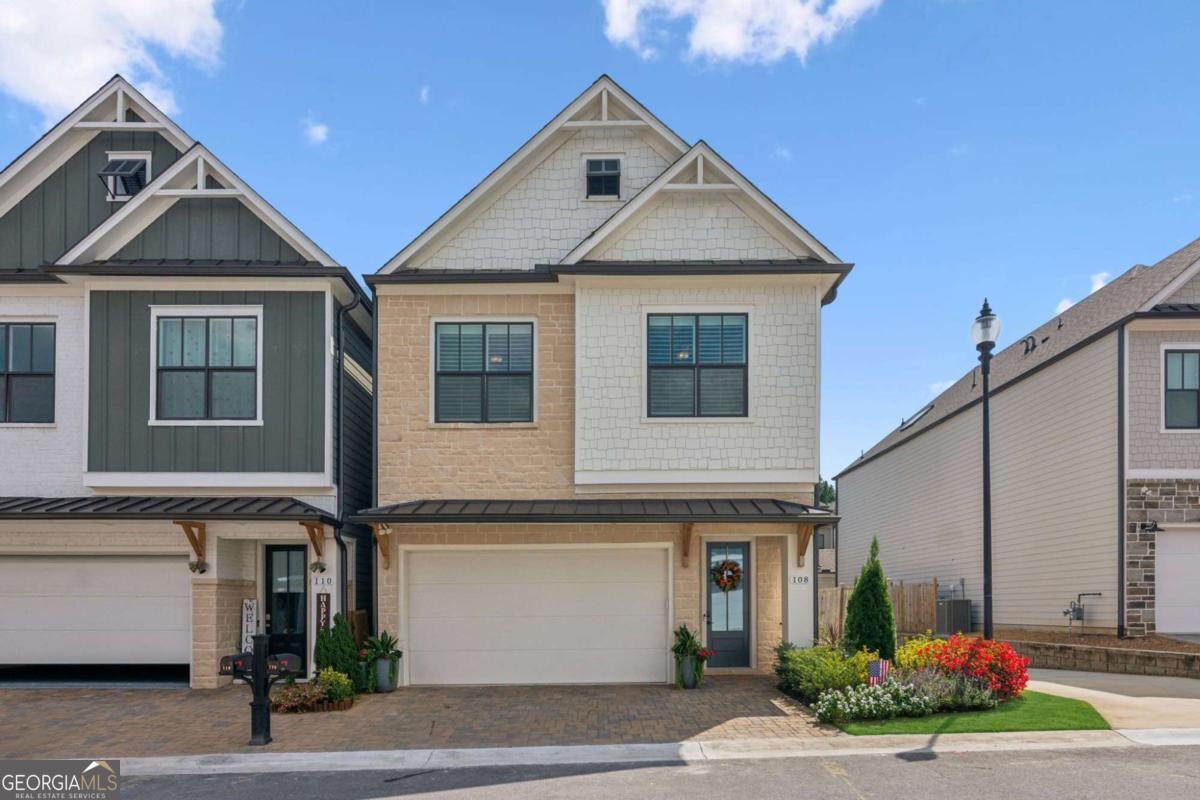 Brand new to the market, this immaculate 2021 Frisco by Davidson Homes offers a spacious open floor plan on the main level. The gourmet kitchen is perfect for entertaining with a large central quartz island. Stainless steel Kitchen Aid and Whirlpool appliances, high-speed vent-hood, recessed 5 burner gas stove-top, 42" soft close doors and drawers, quartz countertops and an oversized, double-door kitchen pantry with shelves all add to this beautiful home. The cosy living area features a linear electric fireplace, and hardwood floors are in the living areas with ceramic tile in all bathrooms. The homes boasts 11ft ceilings on the main floor, 10ft ceilings on upper floors and 8ft interior doors throughout. Oak-tread stairs with high grade carpet lead up to three carpeted bedrooms and the laundry room with ceramic tile, custom cabinetry and a wash basin. The generous primary bedroom suite has a large shower and double vanities, an oversized closet with 'Spacemaker' design built-ins, and off the primary suite is a private, covered deck with ceiling fan, perfect for your morning coffee. Both additional bedrooms have ceiling fans and walk-in closets with shelving, and custom plantation shutters. Multiple upgrades to the home include: on-demand hot water heater (full home); garage shelving and storage; built-in whole-home Wi-Fi router/extender; custom window treatments throughout, including German-engineered ceramic tint on windows and doors (excluding dining room), motorized, remote-control shades in living and dining room, custom light filtering shades and custom blackout drapes in the primary bedroom. Dual zone HVAC unit with smart thermostats upstairs and downstairs, and custom under-stair security storage. The garage has a Wi-Fi -enabled Smart garage door system and the front and back of the home are landscaped. The upper deck and lower patio could be converted to a screened-in or enclosed porch and the back and side sod areas of the home can easily be enclosed for pets. The village at Towne Lake is not just a beautifully maintained gated community of fabulous homes and excellent amenities, it's a whole lifestyle! The HOA maintains the lawns and pine straw around the home and provides weekly maintenance. The gated community has 2 access entry/exit points. All neighborhood streets are planned to be repaved during 2025. An extensive neighborhood landscaping project was recently completed. The clubhouse has an indoor and outdoor fireplace, pool with tables/umbrellas, gym, pool table and kitchen area; Social events currently include monthly Saturday morning coffee/snacks, book club, and more. There is a large fire pit with seating to enjoy s'mores and socializing, 3 fenced dog parks with artificial turf. Walkable neighborhood with easy access to Woodstock Greenprints trail system and access to vibrant downtown Woodstock.