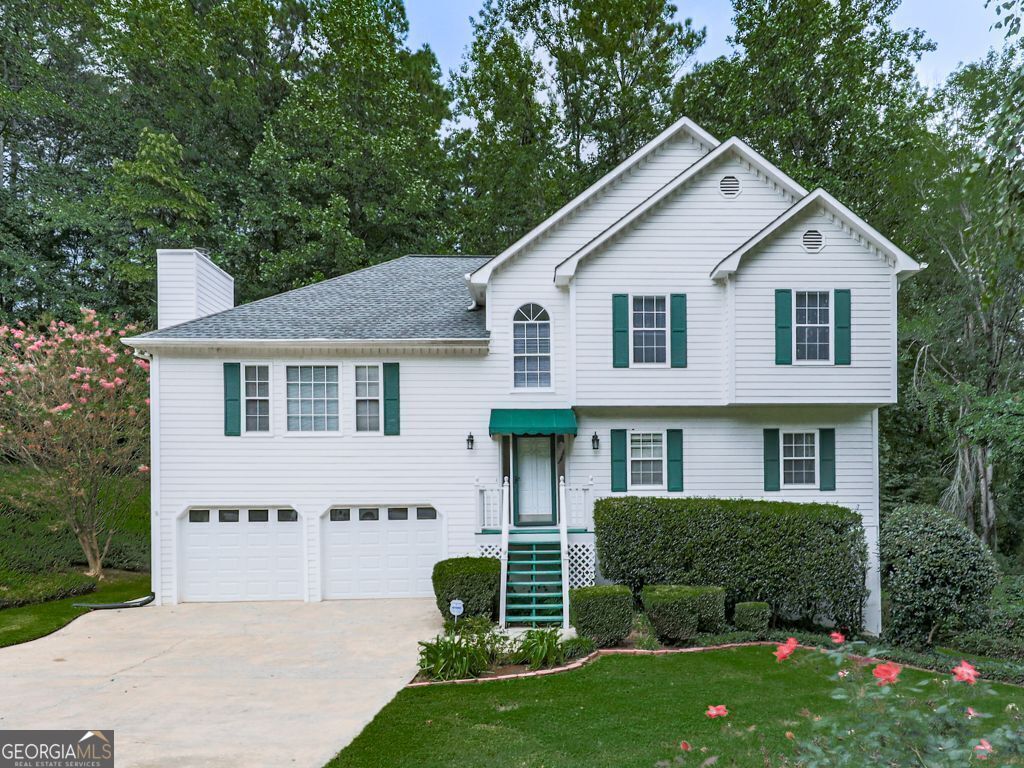 IMMACULATE home in Spicers Grove! NEW carpet and paint throughout! Centrally located in booming Woodstock, close to schools, shopping, restaurants, and a short drive to Downtown Woodstock and all that entails, including free concerts at outdoor amphitheater and weekend Farmer Markets! Plenty of room to roam around in this functional split level. Extensive foyer leads you to the perfect guest retreat or teen suite with bedroom, full bath, large living area and laundry room with utility sink and extra cabinets. Main floor has expansive living room with built- ins flanking convenient gas fireplace. Nicely laid out kitchen has stainless appliances and large eat in area for quick meals or if you need more space for family and guests, the formal dining area has trey ceilings and overlooks one of the 4 back deck areas. Oversized primary has two closets and massive ensuite with double sinks, separate shower and soaking tub. Ample secondary bedrooms round out this picture perfect home. Flat front yard with huge shade tree and landscaping. Multiple back deck areas are perfect for morning coffee, evening BBQ'S, or just enjoying the private, wooded back yard! Sorry, no pets allowed.