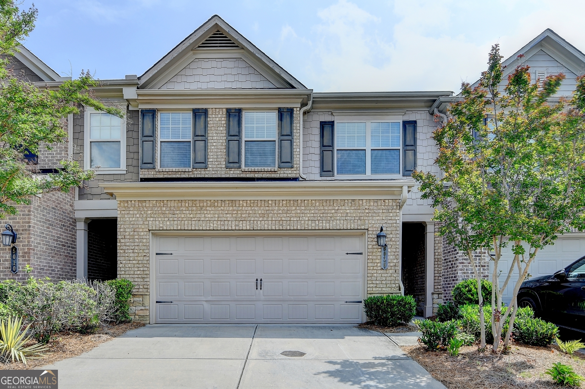 Located in the highly sought-after Johns Creek area, this beautifully maintained 3-bedroom townhome with a spacious loft offers the perfect combination of style, comfort, and convenience. Nestled in a quiet cul-de-sac within a gated community, this home features an open-concept layout that's ideal for entertaining.You will love the charming curb appeal with its brick facade, cedar shake accents, covered front entry, and two-car garage. Inside, hardwood floors, crown molding, and a seamless flow from the dining area to the family room with a cozy gas fireplace create a warm and welcoming atmosphere.The kitchen boasts a center island, granite countertops, stainless steel appliances, a basket weave tile backsplash, and ample prep space, perfect for hosting or everyday living. A half bath completes the main level. Upstairs, the stylish wrought iron staircase leads to a versatile loft, great for a home office, playroom, or lounge area. The primary suite features a tray ceiling, dual vanities, a soaking tub, a walk-in shower, and a generous closet. Two secondary bedrooms, a full bath, and a convenient upstairs laundry room add to the home's thoughtful layout. Relax outdoors on your private patio, enhanced with a wooden privacy partition. Additional features include two Nest thermostats, an irrigation system, and community-maintained exterior and landscaping, allowing for true low-maintenance living. Situated in one of North Metro Atlanta's premier locations with access to award winning, top-rated schools, parks, shopping, dining, and more - this is one you don't want to miss. Showings begin Saturday, 6/7!