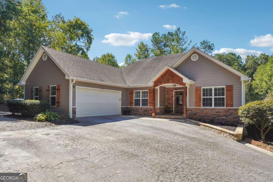 Beautiful ranch-style home on over an acre of private land with NO HOA! Located just minutes from downtown Dawsonville and the North Georgia Premium Outlets, this home offers the perfect blend of comfort and convenience. The main level features an open-concept living area with vaulted ceilings and abundant natural light. The kitchen is equipped with granite countertops, stainless steel appliances, and flows seamlessly into the spacious living and dining areas. The primary suite on main includes double vanities, a separate tub and shower, and a generous walk-in closet. Two additional bedrooms and a full bath complete the main floor-ideal for family or guests. The partially finished basement includes a full bedroom, full bath, and an additional flex space perfect for an office, media room, or gym. Ample storage or potential to finish even more space! Outside, enjoy a newly installed 50x40 shop with private entry and plenty of parking. Don't miss this rare opportunity in a prime location-schedule your showing today!