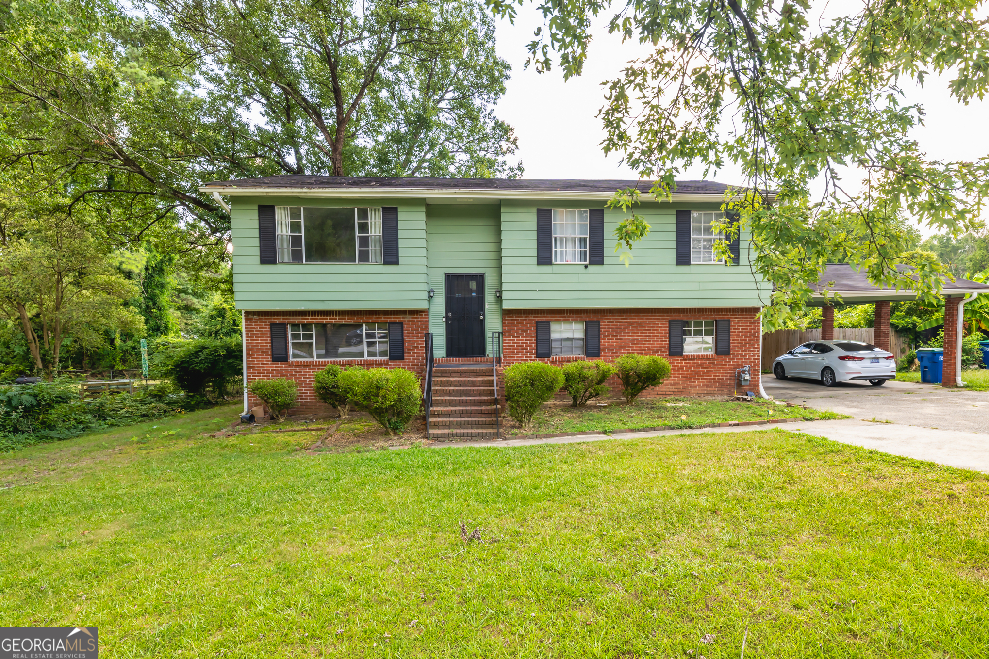 Don't miss this incredible opportunity to own a beautifully maintained split-foyer home offering space, flexibility, and income potential - all in a prime location just minutes from Atlanta! This spacious property features 5 generously sized bedrooms and 3 full bathrooms, perfect for a large or growing family. The standout feature is the income-producing mini apartment on the lower level, complete with its own private entrance, full kitchen, and bathroom. Whether you choose to rent it out, use it as an in-law suite, or offer it to guests, this space adds exceptional value and versatility. The main level of the home boasts an open and inviting floor plan with an abundance of natural light. The fully fenced, level backyard is ideal for outdoor activities, pets, or simply relaxing . Situated in an amazing location, this home is just 5 miles from Hartsfield-Jackson Atlanta International Airport, 10 miles from downtown Atlanta and Mercedes-Benz Stadium, and only 5 minutes from I-85 and I-285, making it perfect for commuters and travelers alike. You'll also be near shopping, dining, parks, and schools. Whether you're looking for a personal residence with room to grow or a smart investment property with rental income potential, this home checks all the boxes. Schedule your showing today and experience the perfect blend of comfort, convenience, and opportunity!