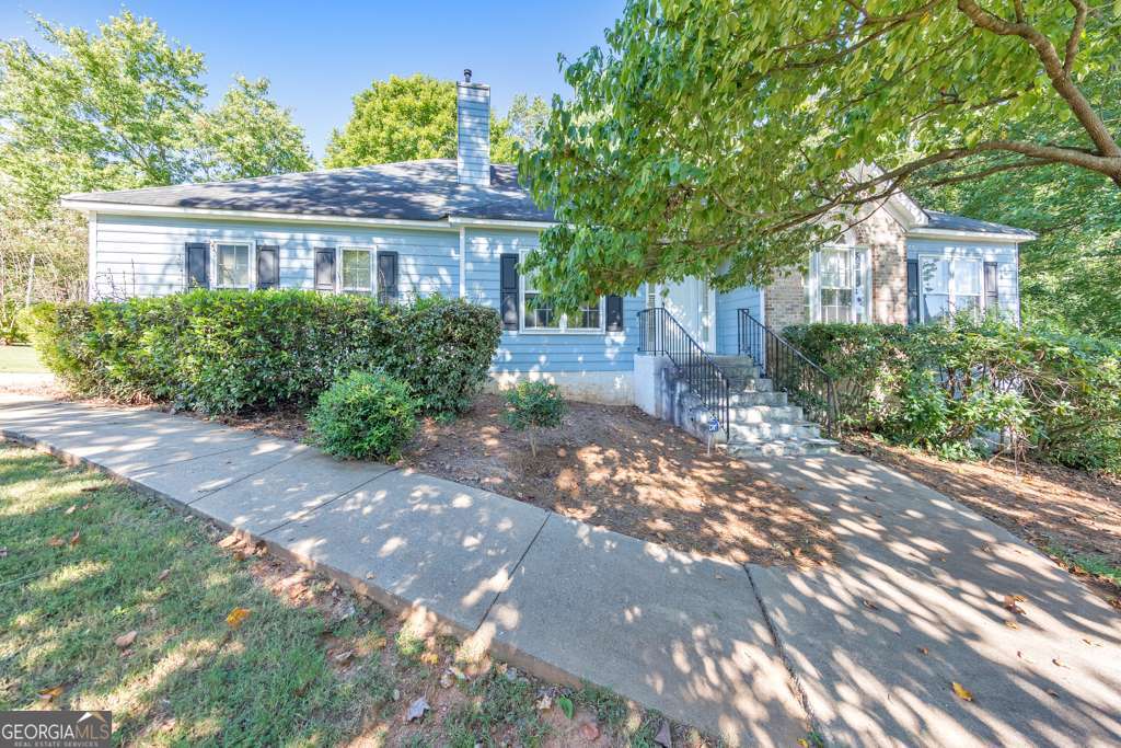 Welcome to this charming 3 bedroom / 2 bathroom ranch, perfectly situated on a spacious 0.344-acre corner lot in the desirable community of The Overlook! Step inside to find a warm fireside family room with soaring vaulted ceilings, ideal for both everyday living and entertaining. A separate dining room flows seamlessly into the kitchen, complete with white cabinets, a pantry, and a generous breakfast room. A convenient laundry room is located just off the kitchen. The inviting primary suite boasts tray ceilings, an ensuite bathroom with dual vanities, a relaxing whirlpool tub, a separate shower, and a walk-in closet. Two generously sized secondary bedrooms share a full hall bath. Enjoy outdoor living on the rear deck overlooking the private backyard. Additional features include an attached 2-car garage and access to community amenities such as a sparkling pool and tennis courts. All in a prime location with easy access to Marietta Square, Dobbins Air Force Base, and an abundance of shopping and dining options!