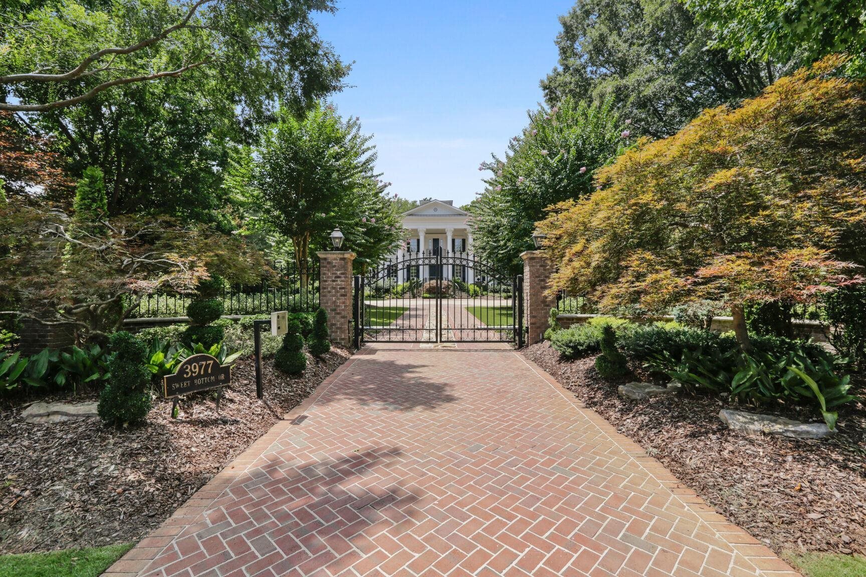 Welcome home to one of the most renowned properties in North Atlanta - located on the picturesque Chattahoochee River. This stunning Greek Revival estate has enduring historical elements, unsurpassed craftmanship, and exquisite design creating an elegant blend of southern grandeur and modern luxury. Private security gate leads to large motor court for guest parking, 26-foot Corinthian columns, and distinctive double sweeping staircase leading to the grand front porch. Front windows swing open for distinguished entertaining with indoor/outdoor flow. Luxurious interior is adorned with 14-piece moldings, 13 fireplaces, custom cabinetry and floors, and elevator servicing all 4 levels. Recently renovated kitchen features striking marble countertops, two built-in lighted china hutches, and unique hardwood floors with brick inlay. Huge master suite offers three walk-in closets, spa bath, and gorgeous views. In-law suite attached to the two-car garage is ideal for multi-generational living and includes full kitchen, bedroom, bathroom, and living area. The spacious secondary bedrooms include fireplaces and baths. Handsome terrace level has fitness room, upscale theater, and enclosed patio with large spa. Relax by the sparkling blue pool surrounded by lush gardens. Gather by the warm firepit on the banks of GeorgiaCOs famous Chattahoochee River Co a great place to kayak, fish, or just enjoy a gorgeous sunset. Truly graceful southern living with masterfully interwoven charm, elegance, grandeur, and modern delights!