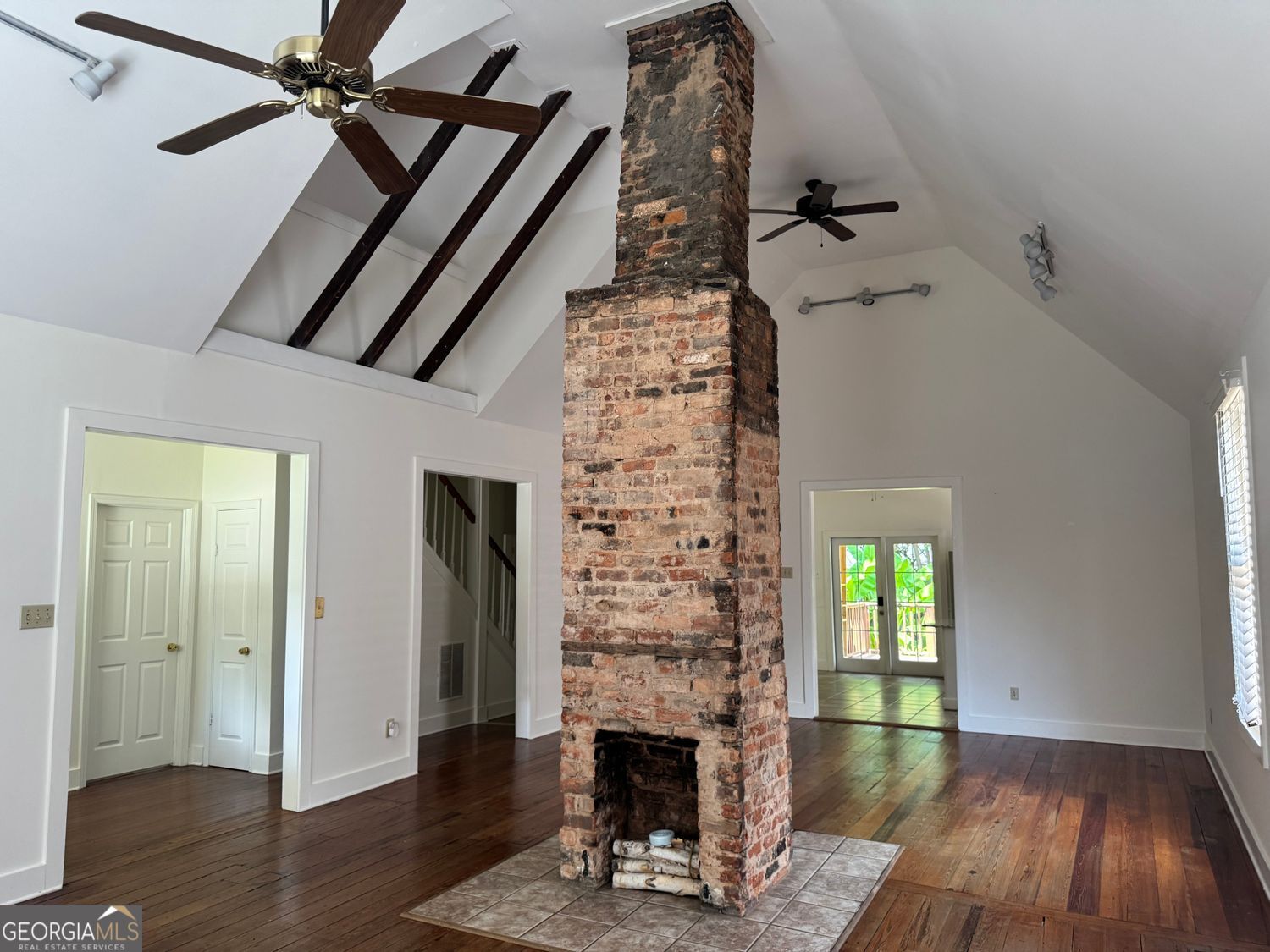 Discover the perfect blend of historic charm and modern lifestyle in this enchanting Cabbagetown home. Built in 1920, this historically registered home is thoughtfully updated, 199 Pearl Street SE offers 2 bedrooms, 2 full baths, and a flexible loft space ideal for working, creating, or relaxing. Inside, original heart-pine hardwood floors shine under natural light, complementing the open layout and stainless steel kitchen finishes. Enjoy daily comforts with in-unit laundry and central air. Updated closets with plenty of storage space are found throughout. The fenced backyard, graced with banana trees, is a tranquil retreat, while off-street parking-rare for this neighborhood-provides added convenience. This property is ideally suited for those seeking character-rich living just steps from the BeltLine's greenway, shopping, and dining. This rare rental opportunity combines historic charm, walkability, and space - perfect for professionals, creatives, or anyone who values living in one of Atlanta's most iconic neighborhoods.