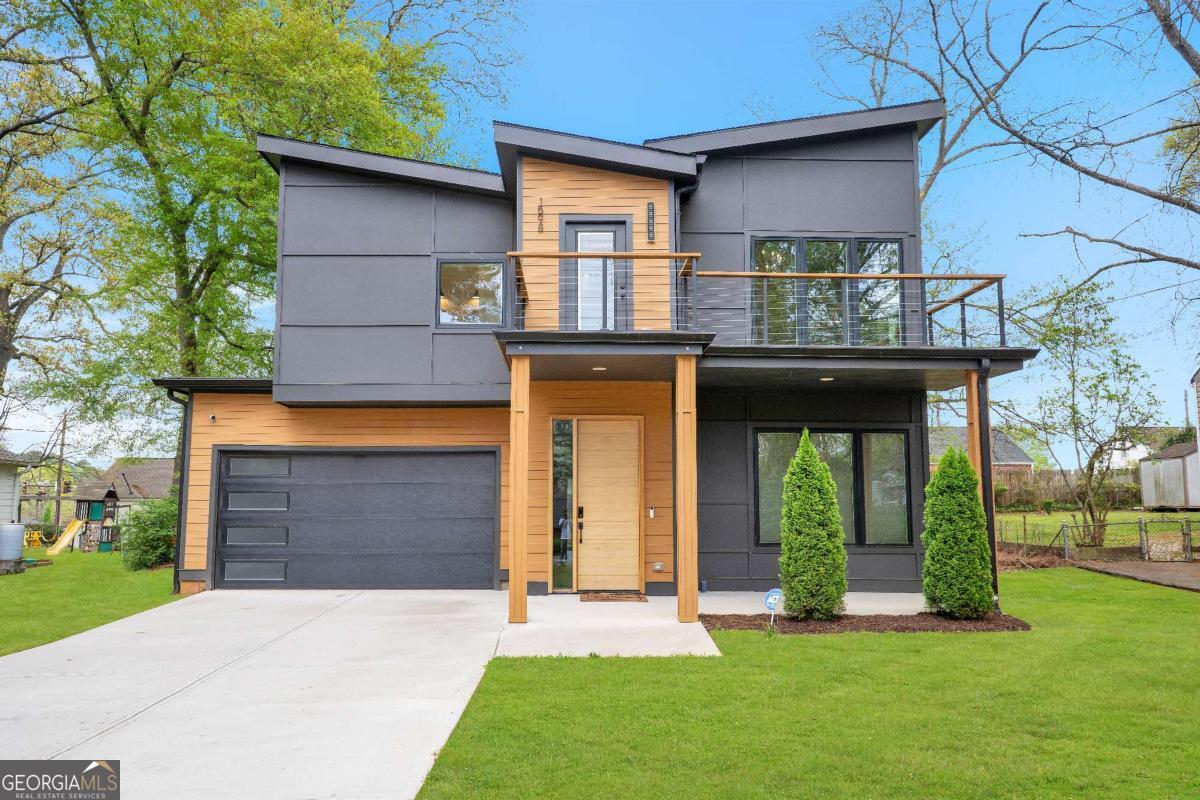 Price Improvement! Modern Luxury in Capitol View 4 Beds, 3.5 Baths. Experience sleek modern living in this architecturally stunning 4-bedroom, 3.5-bath contemporary home, now offered at an improved price in the vibrant Capitol View neighborhood of Atlanta. This thoughtfully designed residence showcases soaring ceilings, premium hardwood flooring, and an open-concept layout ideal for both everyday living and entertaining. The chef's kitchen is a true showstopper, featuring high-end stainless steel appliances, a wine fridge, custom cabinetry, and a massive 10-foot island that seamlessly connects to the dining and living areas. Enjoy custom built-ins, a cozy fireplace, and oversized sliding glass doors that open to a covered patio-perfect for indoor-outdoor entertaining. Upstairs, the spacious owner's suite offers 12-foot ceilings, a private balcony, an accent wall, custom walk-in closet, and a spa-like bath with soaking tub, oversized walk-in shower, and designer finishes. Two additional upstairs bedrooms share access to a second balcony and a full bath, while a fourth bedroom on the main level adds flexible space for guests or a home office. Additional features include ample natural light throughout, professional-grade finishes, and a location that places you minutes from the BeltLine, Mercedes-Benz Stadium, Downtown, Midtown, Hartsfield-Jackson Airport, and major interstates. No HOA. Preferred lender incentives available. This property also qualifies for special financing, including 100% financing with no private mortgage insurance (PMI), no income limit, and a minimum credit score requirement of just 620. Buyers may also receive up to $9,000 in free grant funds that do not need to be repaid. Don't miss your chance to own this modern gem in one of Atlanta's fastest-growing communities!
