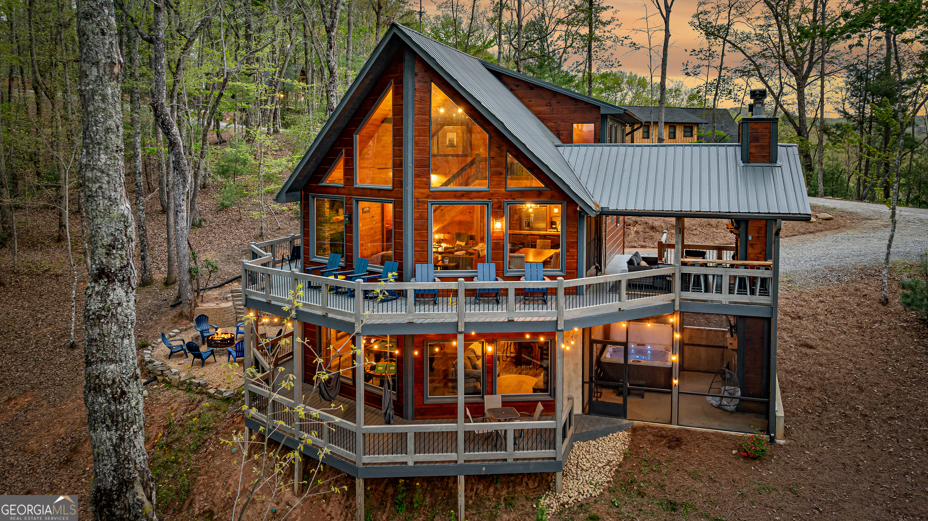 This beautifully maintained, fully furnished 4-bedroom, 3.5-bath cabin is nestled in the highly coveted Blue Ridge area and offers a rare blend of lifestyle and investment. Not only is "Morning Glory" a stunning private getaway, it's also a successful vacation rental with a strong track record of income, making it an ideal opportunity for investment-minded buyers or anyone seeking a profitable second home. Step inside and be greeted by an expansive open floor plan, dramatic floor-to-ceiling windows, and sweeping long-range mountain views. Exposed wood beams, soaring cathedral ceilings, and three impressive stone fireplaces create the perfect mountain ambiance. The chef's kitchen is equipped with stainless steel appliances, granite countertops, and ample cabinetry-ideal for family gatherings and entertaining. The main-level primary suite is a true retreat, offering a spa-like ensuite with soaking tub, double vanities, and a beautifully tiled walk-in shower. Upstairs, a bright loft leads to two spacious bedrooms and a modern bath. The terrace level is designed for entertaining, with a stylish wet bar, cozy fireplace, and chic bunk room for movie nights or extra guests. Abundant storage keeps gear organized year-round. Step outside to enjoy screened porches, a hot tub, and a firepit under the stars-perfect for relaxing or entertaining after a day exploring North Georgia. Located just minutes from downtown Blue Ridge, the Aska Adventure Area, dining, shopping, and local wineries, this cabin puts you at the heart of the region's best attractions. Priced below market value, "Morning Glory" delivers outstanding comfort, luxury finishes, and established rental history-making it a smart choice for your next investment. Key Features: Proven short-term rental income, Fully furnished & turnkey, Long-range mountain views, Hot tub, fire-pit, & screened porches, Three fireplaces & terrace-level wet bar, Minutes to Blue Ridge & Aska Adventure Area. Reach out for our video tour!