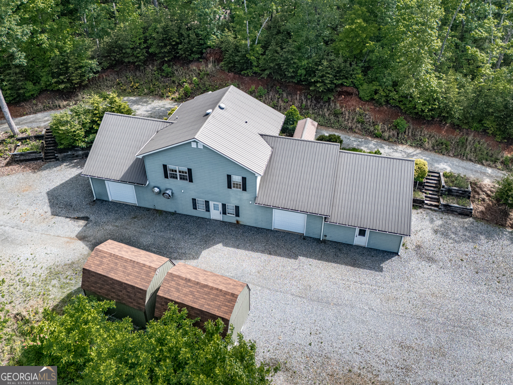 118 ACRE ESTATE with LONG RANGE Mountain Views! The main house is divided into two separate levels with separate entrances to each floor. The upper floor features an open concept kitchen and great room, 3 bedrooms and 2 baths and a large bonus room where stairs to the lower level could be reinstalled. The lower level of the home has multiple roll up doors for parking vehicles. A large kitchen with some commercial items to remain with home, adjacent to a mens and women's restroom, complete with shower stalls. There are two 16 x 12 outbuildings providing additional storage. There is a fenced in garden area with fruit trees and its own irrigation. There is a spring on the property to the South. Shown by appointment only.