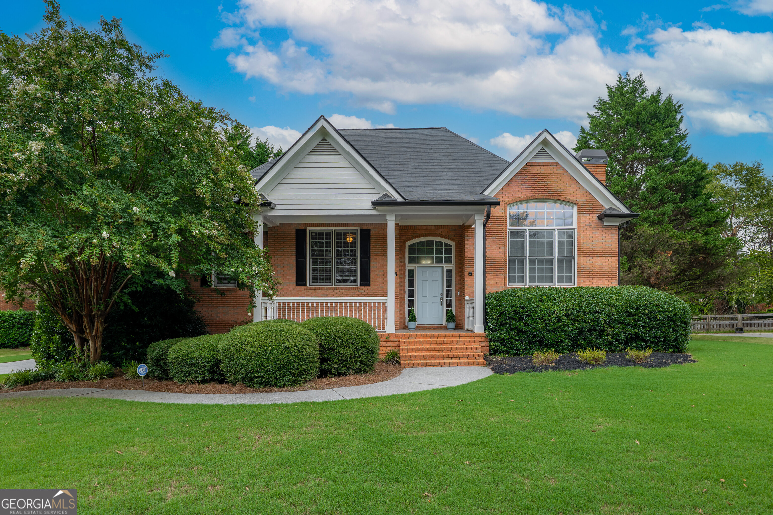 Welcome to 11 Hampton Lane, a stunning Cartersville gem, nestled in the coveted Waterford community! This exquisite 3-sided brick home captivates with its sophisticated charm and thoughtful design. The heart of the home is a bright living room, anchored by a cozy gas fireplace, gleaming hardwood floors and exquisite picture windows. Entertain with ease in the open concept dining area or gather in the gourmet kitchen, featuring crisp white cabinetry, a pantry, stainless steel appliances, a breakfast bar, and a sunny dining nook with direct access to a brand-new, expansive upper deck-ideal for morning coffee or sunset soirees. The primary suite is a serene retreat, boasting elegant tray ceilings and a luxurious en-suite bath with a double vanity, separate shower, tiled floors, and a relaxing jet tub. Downstairs, a versatile lower level offers a spacious family room, a fourth bedroom, and a full bath, with doors opening to a huge, flat back yard that's just screaming for a pool! The fully fenced backyard, newly installed for complete privacy, creates a peaceful oasis for outdoor enjoyment. Additional highlights include new garage doors for the double car garage, complete with a separate storage area or workshop! The Waterford presents a collection of exceptional amenities, including a clubhouse, Olympic-size pool, tennis and pickleball courts, clubhouse, playground, and cabana. Directly across the street, Dellinger Park offers wooded running trails, a city pool, athletic courts, picnic pavilions, and a tranquil pond. Zoned for Cartersville City Schools and just 7 minutes from downtown, residents enjoy convenient access to shopping, dining, and the vibrant culture of Cartersville. Grab this sweetheart of a deal while you can!