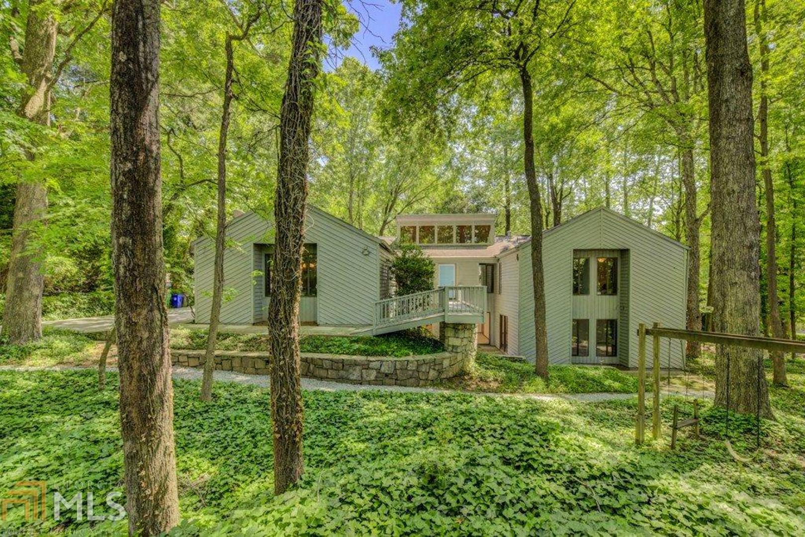 Distinctive split-level family home on shaded corner lot. Flexible flrpln allows for multi-generational living w/ potential for income. 3BEDSx2.5BATHS up & 2BEDSx1BATH down. Striking architectural details: soaring tongue & groove ceilings, clerestory windows, foot bridge entry, stone frplc, & multiple glass doors opening onto rear deck (perfect for family gatherings!). Well-maintained kitchen opens onto dining/living room. MCM fans will LOVE the vintage blue & brown baths. Kid-friendly n'hood is walkable to schools & community pool. Fenced rear yard is ready for pets