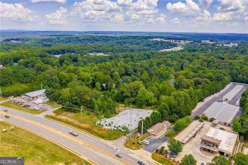 Beautifully level lot with Approx 35,000 square feet on Bells Ferry Road, Next door to Kaotic Kustoms Motorcycle shop at end of Eagle Drive. Old Mobile home park that has been cleared. All utilities available. No Structure on property. Mixed use/commercial development opportunities.