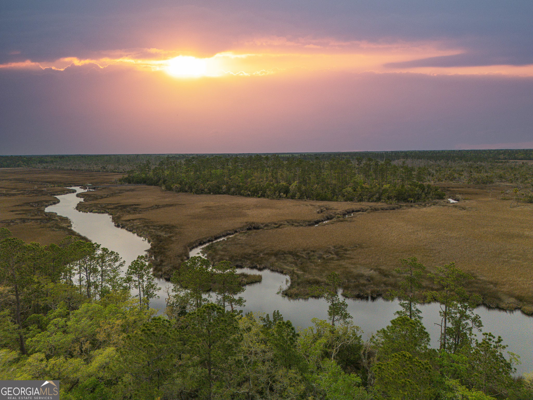 Welcome to your dream waterfront property! This stunning 1.2-acre lot boasts water access, perfect for boating, fishing, and nature enthusiasts. Located in a prestigious gated community, this prime piece of land is just minutes away from I-95 and the beautiful beaches of Jekyll Island. Enjoy breathtaking sunsets over the west-facing creek and salt marsh while enjoying lush surroundings of mature pines and palms on your very own property. Don't miss out on this opportunity to build your perfect oasis in this desirable location. Start living the luxurious coastal lifestyle you've always dreamed of!