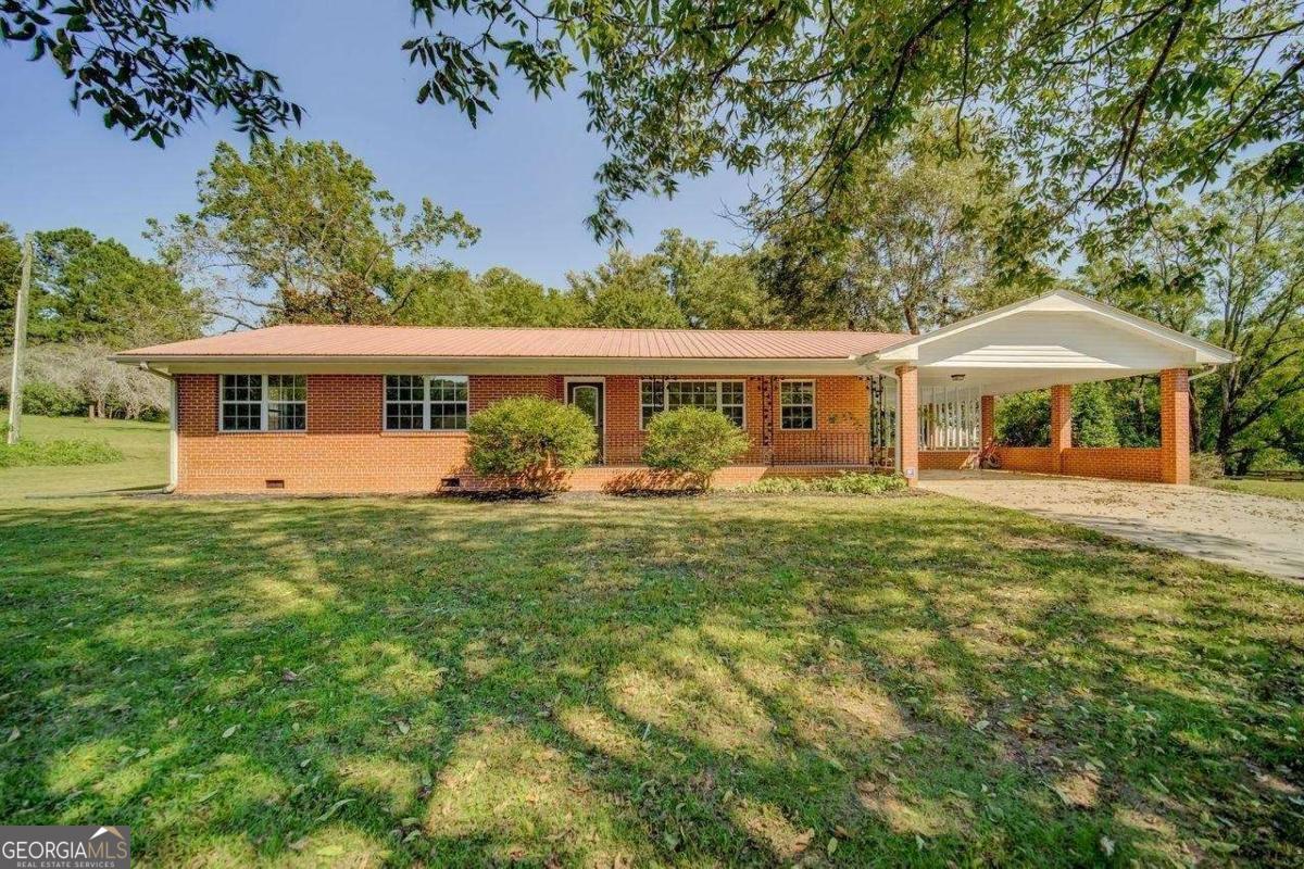 Welcome to peaceful country living! This 3BR/2BA 4-sided brick ranch sits on 2.03 private, level acres in Canton. Inside, you'll find a spacious layout with a living room, dining room, and kitchen, plus hardwood and laminate flooring throughout for easy care. Relax on the covered front porch, park under the 2-car attached carport, and enjoy the extra touches this property offers - a gazebo for outdoor gatherings, a small barn for storage, and plenty of open land. If you're looking for privacy, space, and a touch of rural charm while staying close to Canton conveniences, this home is a perfect fit. Flexible rental terms available: month-to-month or yearly!