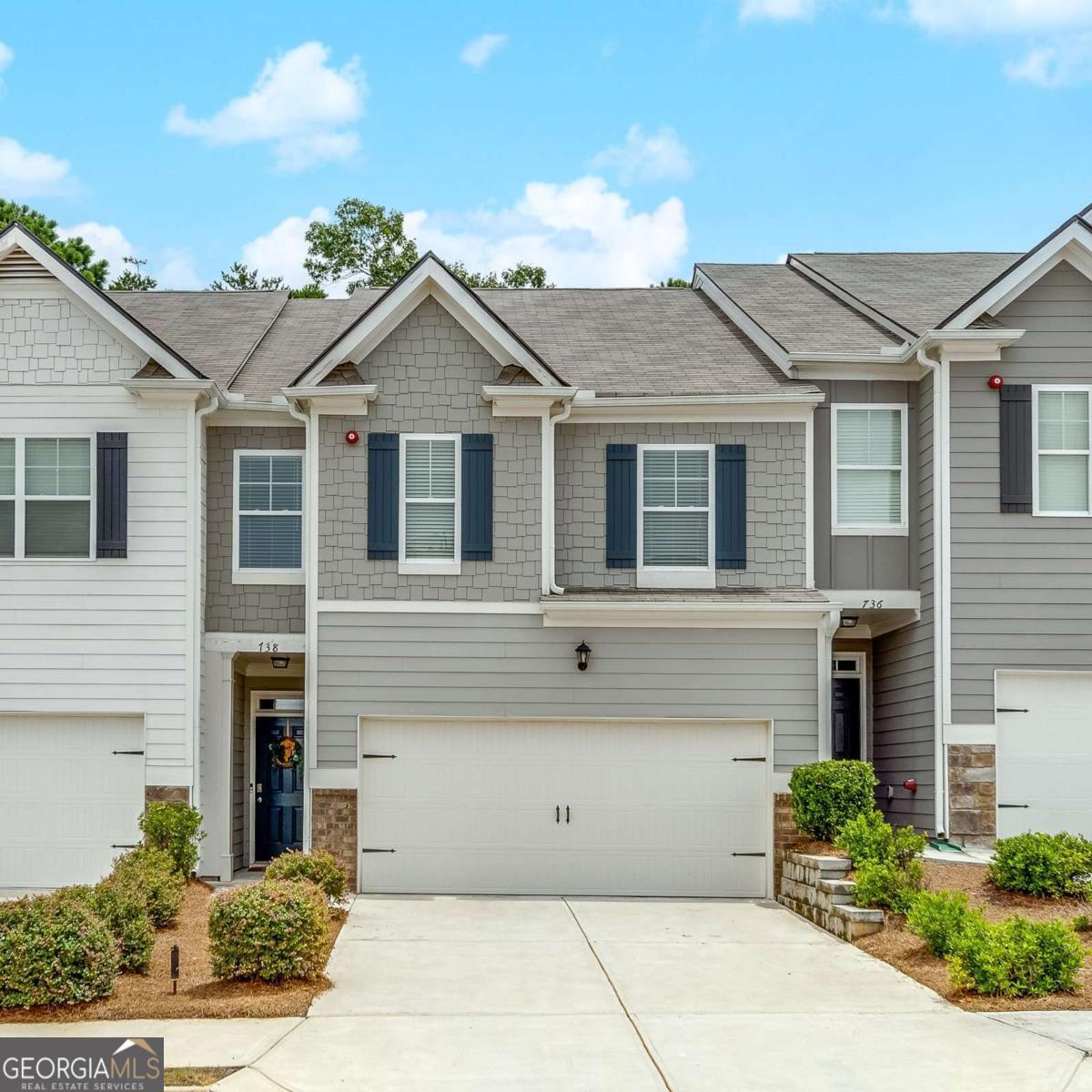 This open floorplan townhome checks all the boxes. Less than 5 years young - LVT flooring throughout the main level - spacious kitchen with plenty of cabinetry, granite counters, large center island, recessed lighting, stainless steel appliances and view to the family room. Upstairs you will find an oversized primary bedroom with a spacious bathroom with walk-in shower, large tub, double vanity, large linen closet, and a large walk-in closet. Two additional bedrooms and another bathroom with double vanities. The backyard overlooks wooded area great for enjoying coffee or end of the day relaxation on the patio and is fenced in - 6ft privacy on the sides and wrought iron along the back - photos taken prior to fence being installed. Conveniently located near Downtown Woodstock, Roswell, major interstates, shopping, restaurants and more.