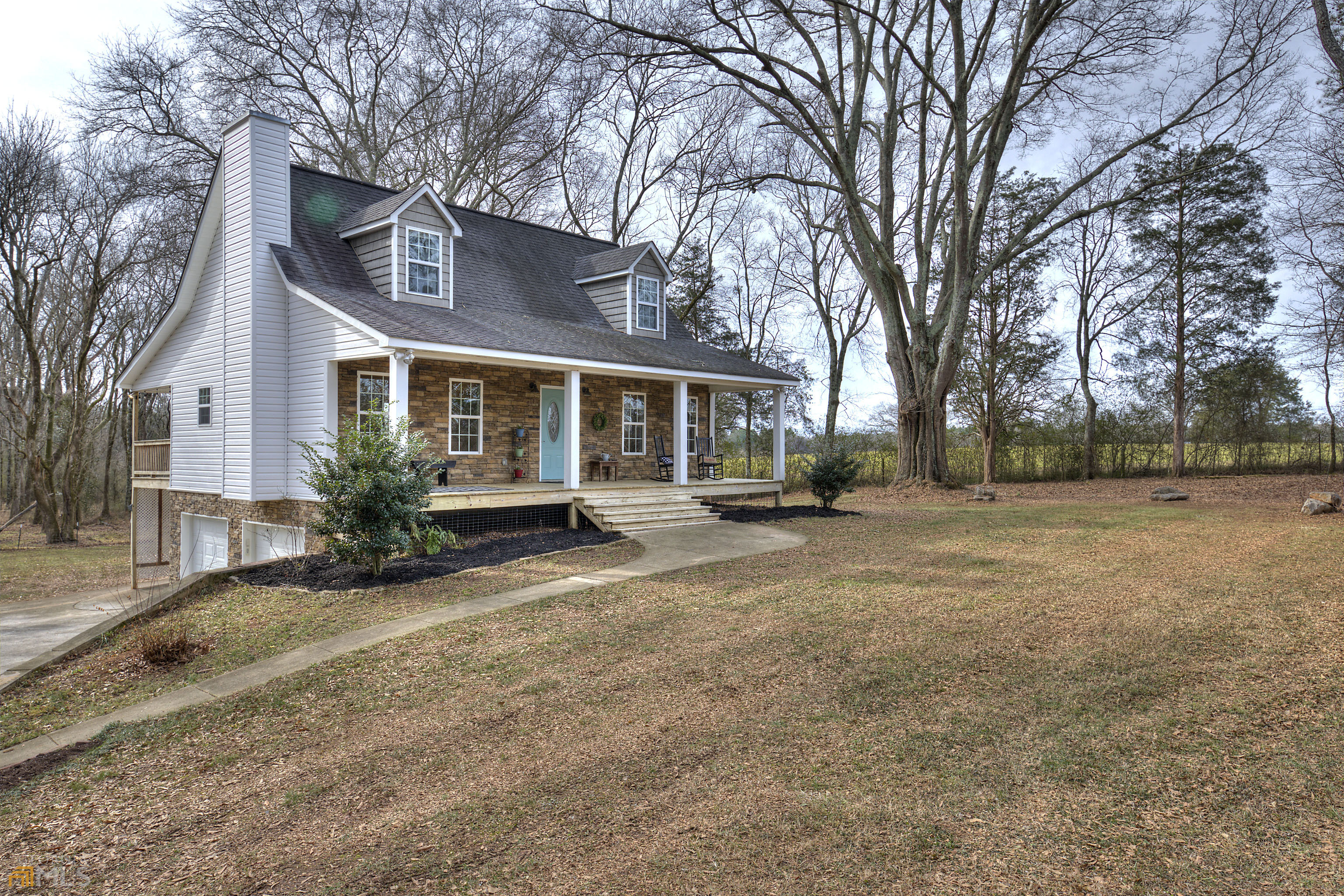 This gem on Georgia Lane will not disappoint. The privacy gate into the driveway keeps this home tucked away from hustle and bustle. The rocking chair front porch spans the entire front of the home. As you enter the front door you are greeted with rich, brown hardwood flooring throughtout the living room, kitchen, and stairway to the second level that leads to 2 separate bedrooms and a full bath. Matching LVT flooring has been installed in the owners' bedroom on the main floor. The owners' suite includes a large soaking tub, double vanity, and separate stand up shower. The kitchen opens up to the back deck where you can enjoy the outdoors while staying cool in the shade. Don't forget the downstairs bonus room which could easily become an office or craft room...so many options. This home doesn't lack in storage space. The closets are numerous and spacious. Call today for a showing! This home and its setting is full of charm and will have you feeling at home in no time!