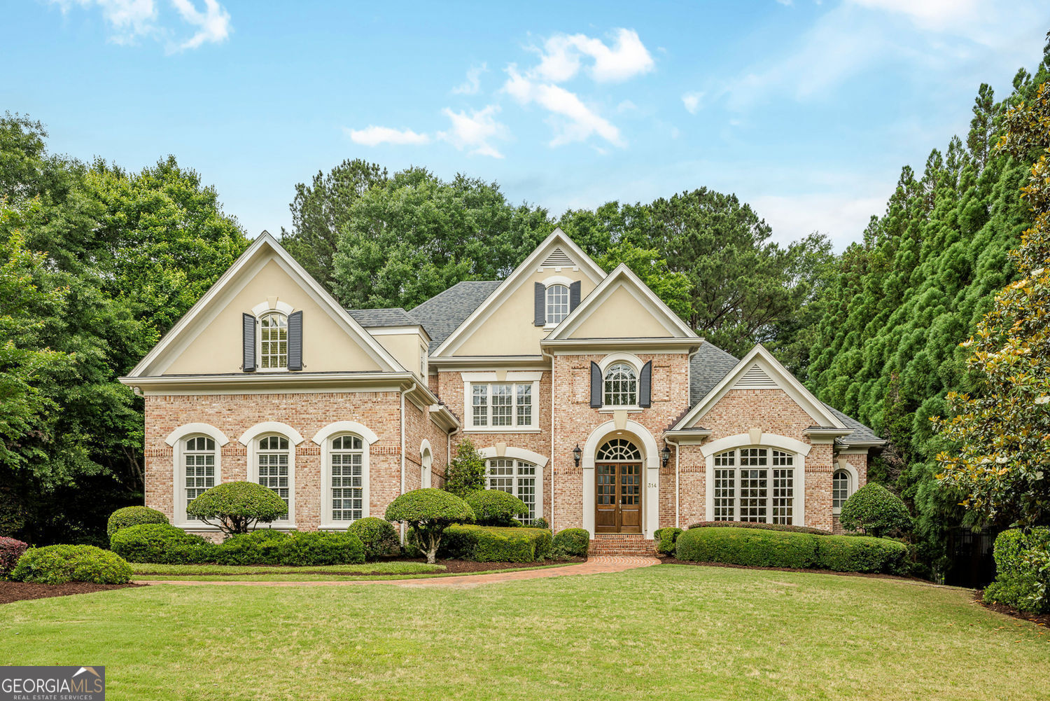 Exquisite Chattahoochee Riverfront Estate in Sentinel Ferry! Welcome to this rare and elegant riverfront retreat in the prestigious gated swim and tennis community of Sentinel Ferry. Perfectly situated on a level lot with sweeping views of the Chattahoochee River, this custom-built home offers a seamless blend of luxury, comfort, and natural beauty-all in one of Sandy Springs' most desirable locations. Step inside to a dramatic two-story foyer that sets the tone for the home's refined interiors. A richly paneled study with built-in bookcases and a fireplace provides the perfect space for a private office or library. Opposite, the banquet-sized dining room impresses with elegant wainscoting and a tray ceiling, ready to host gatherings both large and intimate. The light-filled two-story great room features soaring Palladian windows that frame breathtaking river views, complemented by custom built-ins and a stately fireplace. Just off the great room, a covered deck offers a peaceful perch overlooking the lush, private backyard and the tranquil waters beyond-ideal for morning coffee or evening entertaining. The heart of the home is a chef's dream kitchen, beautifully outfitted with painted cabinetry, quartz countertops, a stylish tile backsplash, and a large center island with breakfast bar seating. High-end stainless steel appliances include a Wolf gas cooktop and double ovens, while a coffee bar with beverage cooler and a walk-in pantry add thoughtful convenience. The kitchen flows effortlessly into the sunny breakfast room and a beamed family room with a cozy stone fireplace-perfect for relaxed everyday living. Also on the main level are two powder rooms, including one located within the spacious laundry room-offering both functionality and convenience for daily living and entertaining. The main-level owner's suite is a luxurious sanctuary, featuring a tray ceiling, a sitting area with a double-sided fireplace, and large windows that invite in natural light. The spa-like bath includes a double vanity, a glass-enclosed shower, soaking tub, and his-and-hers walk-in closets with custom closet systems for ultimate organization. Upstairs, four spacious secondary bedrooms provide flexible space for family and guests. Two bedrooms feature private en-suite baths, while the remaining two share a well-appointed Jack-and-Jill bath. Each room offers generous closet space and natural light. A large bonus room, accessible via a separate rear staircase, makes an ideal playroom, media space, or teen retreat. There's also a walk-in attic for additional storage. The fully finished daylight terrace level opens up a world of possibility. Designed for entertaining, it includes a media room, wine cellar, and a game room with a full bar. A private guest bedroom and full bath make it perfect for visitors or multigenerational living. An exercise room and a flexible-use room-ideal for a home office, craft room, or additional bedroom-round out this incredibly versatile space. Step outside to a covered patio and enjoy seamless access to the backyard and riverfront beyond. This home is freshly painted, with hardwood floors on the main level, new flooring on the terrace level, high ceilings, detailed millwork, and designer finishes throughout-every detail has been thoughtfully curated to offer both beauty and function. Located in the heart of Sandy Springs, you're just minutes from top-rated public and private schools, Dunwoody Country Club and Golf Course, parks, trails, and vibrant shopping and dining districts. With easy access to major interstates, this is a location that keeps you connected to everything Atlanta has to offer while allowing you to retreat to your own private riverside sanctuary.
