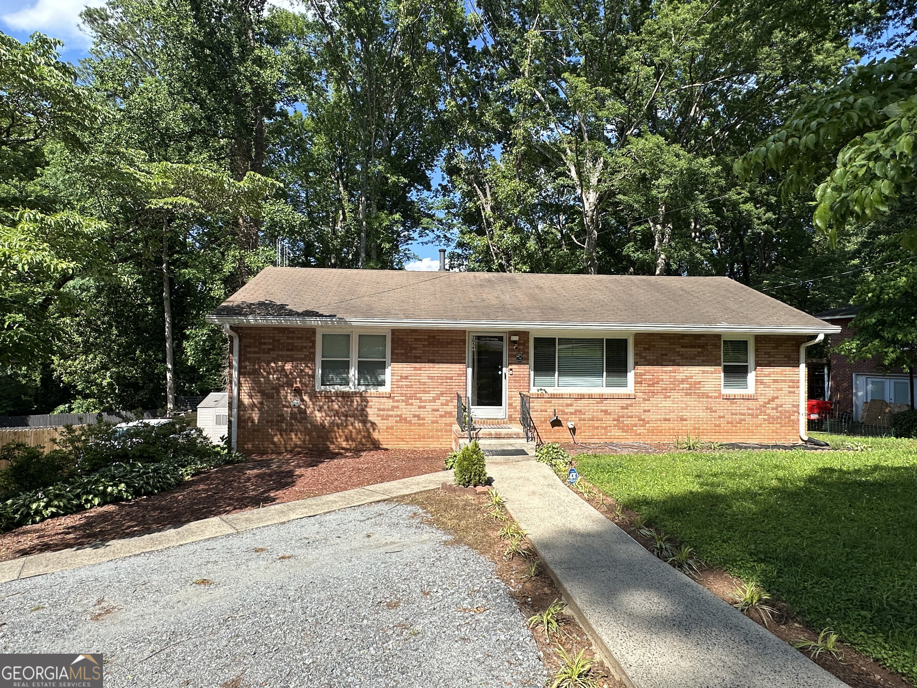 Welcome to 2059 Clearwater Drive, a beautifully maintained 4-sided brick home in the heart of Marietta, offering an exceptional blend of comfort and investment potential. This home, with no HOA, features extensive upgrades and is ideally located just off Powers Ferry Road, providing easy access to major routes, shopping, dining, and more. The property is perfect for multi-generational living or generating rental income, thanks to the two custom-designed basement efficiencies with independent access. The main level boasts a bright living room, dining area, updated kitchen with integrated laundry, 2 bedrooms, and 1 full bath. Efficiency #1: Side entrance with elegant French doors, full kitchen, living room, 2 additional rooms that can be used as bedrooms, spacious bathroom, and laundry. Efficiency #2: Rear deck entrance, 1 bedroom, full bath, and kitchenette (no laundry). Additional highlights: Large wooden back deck, perfect for outdoor entertaining New LED light fixtures throughout Extensive security system with multiple new cameras Partially fenced backyard with ample parking Furniture may be included, if desired by the purchaser Location Perks: Convenient access to Powers Ferry Road and nearby Interstate 75, making commuting to downtown Atlanta, Cumberland Mall, and Truist Park a breeze. Just minutes from The Battery Atlanta and Cumberland Parkway, offering a variety of dining, entertainment, and shopping options. Located in a quiet neighborhood, yet close to major conveniences, offering the best of both worlds. This property has been intensively modified and thoughtfully maintained, offering not only comfort and style but also significant investment potential in a prime, well-connected location.