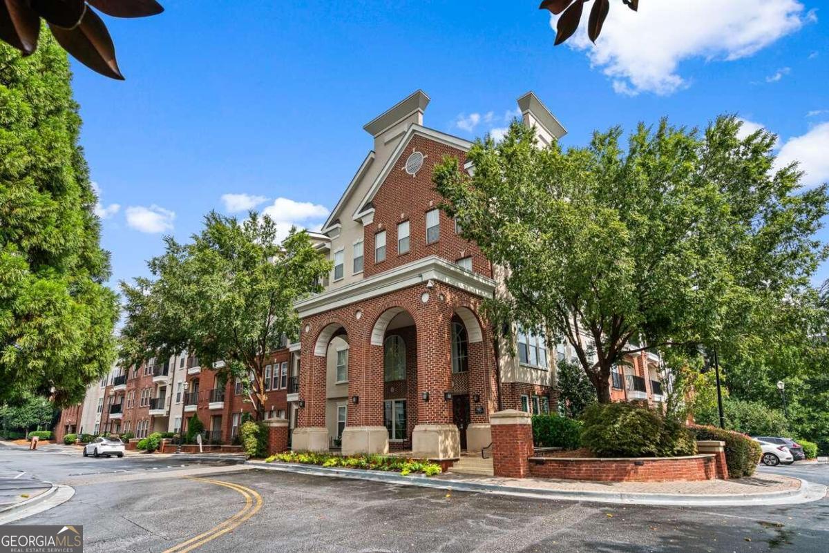 This spacious 2 bd/2 ba condo boasts an open floor plan with elegant touches including hardwood floors, crown molding throughout, arched entryways and wainscoting. The 300 building is located in a quiet section of Madison Square, featuring a peaceful garden. The unit's layout includes a nook that is perfect for a WFH office space or a coffee bar. The oversized primary suite features walk-in closets and a luxurious en suite bathroom, providing the ultimate comfort and privacy. A generously sized secondary bedroom with en suite, on the opposite side, offers ample space for guests or family members and also provides maximum privacy. Enjoy resort-style amenities such as a zero-entry swimming pool, lap pool, state-of-the-art fitness center, clubhouse with meeting rooms, grilling areas, and beautifully landscaped gardens. The pet-friendly community also offers walking paths with fountains, perfect for strolls with your furry friend. BONUS = please note the condo has two deeded, covered parking spaces as well as a storage unit! All appliances remain with the property. Located conveniently near Perimeter Mall, Dunwoody Village, Brook Run Park, shops and restaurants, St Joseph's, CHOA, GSU Atlanta & Dunwoody Campus, with easy access to highways, this home offers the perfect blend of luxury, comfort, and convenience.