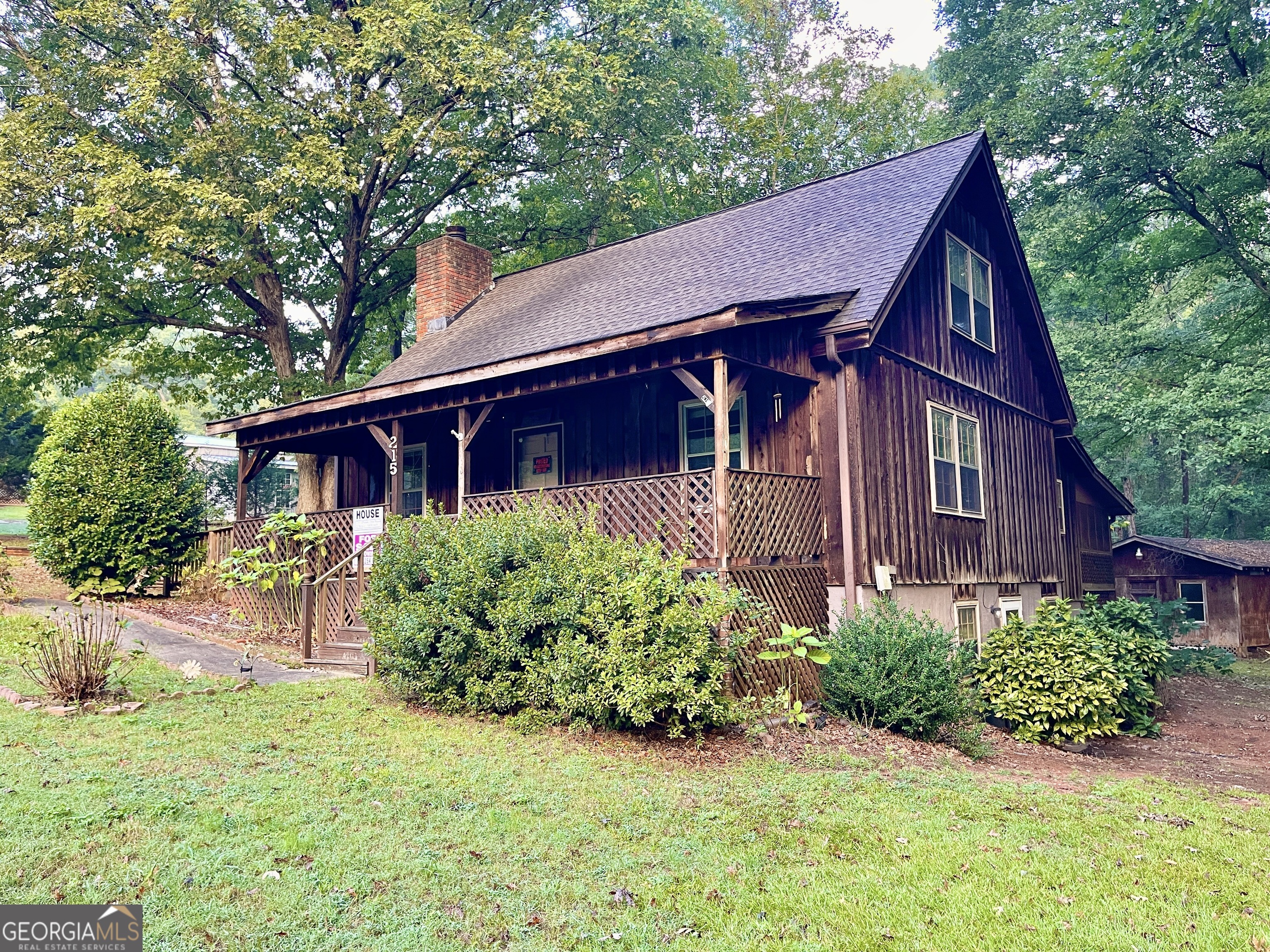 Charming Cabin-Style Home on 2.38 Acres in Winder  Nestled on 2.38 acres of serene, wooded land, this charming cabin-like home offers a peaceful retreat with endless possibilities. Featuring three bedrooms and two-and-a-half bathrooms, the master suite is conveniently located on the main level. The spacious basement presents ample opportunity for future expansion or customization, perfect for creating the space you've always wanted. A large storage building adds extra practicality, while the lush, wooded surroundings provide tranquility and privacy. With rustic charm, acreage, and a listing price well below market value, this home is a fantastic opportunity waiting to be personalized.