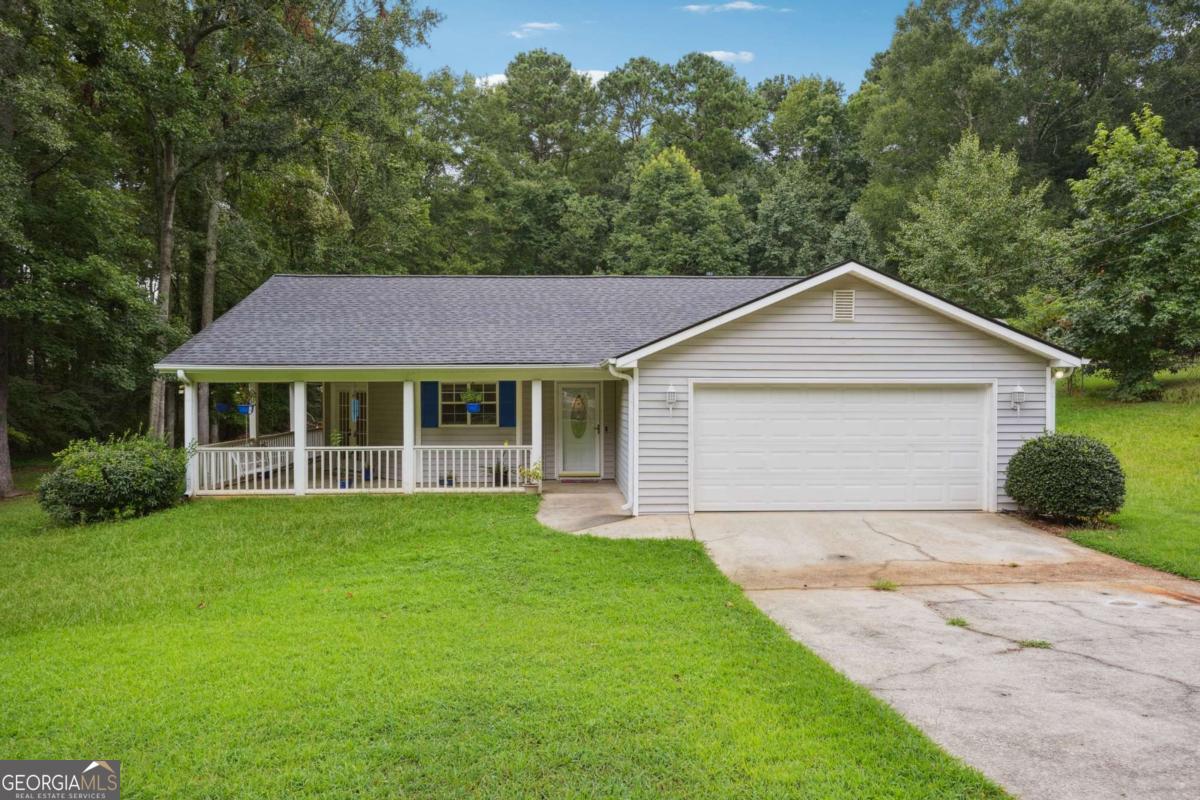 Welcome to your perfect retreat! This charming 3-bedroom, 2-bath ranch sits on nearly a full acre (.93 acres) of beautifully maintained land in peaceful Conyers. Step inside to discover an inviting open floor plan filled with natural light, featuring a spacious living area with fireplace and a well-appointed kitchen ideal for both everyday living and entertaining. The primary suite offers a private escape with its own en-suite bath, while two additional bedrooms provide comfort and flexibility-perfect for guests, a home office, or a growing family. Enjoy the outdoors year-round from the expansive wrap-around front porch or the screened-in back porch, both overlooking your serene, tree-lined backyard-ideal for relaxing mornings or evening gatherings. Whether you're looking for peace, space, or charm, this home has it all. Don't miss your opportunity to own this private slice of Conyers-schedule your tour today!