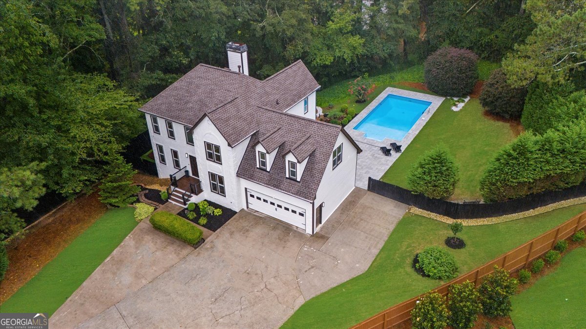 Fresh Renovated Smart Home in Prime Alpharetta Location. Presenting a stunning 6-bedroom, 4.5-bathroom home with the perfect combination of luxury, technology, and convenience-just minutes from downtown Alpharetta and Avalon in a top-rated school district. Nestled in a quiet cul-de-sac on a spacious 2/3-acre lot, the property features a private oasis offering an inground pool, serene pond with waterfall, and ample space for outdoor enjoyment including a playground for the kids. The pool has new beautiful large pavers extending to a great entertainment area for lounging and outside dining. This home is truly like a new home with a well thought comprehensive renovation. Inside, you'll find a freshly remodeled interior with an open modern layout and top-quality finishes. The smart home system connects to Wi-Fi and controls smart light switches, exterior wall lighting, kitchen appliances, thermostats, a whole-home generator for peace of mind, and pool water quality monitoring-all from the convenience of your phone. If you want a home that has most everything this is your home. Walking through the doors you will notice the beautiful hardwood floors, new lighting, hardware, quartz countertops with beautiful quartz waterfall counter, and so much more. The home has had exemplary care providing new paint inside and out, newer windows, new roof, transferable termite letter, new AC Heat pumps. The in-law suite on the terrace level offers 2 bedrooms with ensuite full baths, laundry room, kitchenette and outside entrance. Large parking pad can accommodate an RV/Boat. Extra large workshop with heat and air. A separate storage shed for your pool toys. This is more than a home-it's a lifestyle of comfort, security, and smart living in one of Alpharetta's most desirable areas.