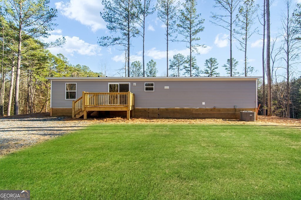 Brand New 2025 Ranch-Style Home on 1.7 Acres - Permanent Foundation, No HOA, Move-In Ready with a mountain view! Don't miss this rare opportunity to own a just-completed 2025 ranch-style home in the peaceful North Georgia mountains-just 10 minutes from Downtown Ellijay! Set on a gently rolling 1.7-acre lot with a permanent metal foundation and retired title (loan-ready), this 3-bed, 2-bath home offers 1,568 sq ft of modern, open-concept living. Highlights include tall ceilings, natural light, stylish finishes, a spacious living room with accent wall, and a chef's kitchen with stainless steel appliances, custom cabinetry, and a large island. The oversized primary suite features a walk-in closet, accent wall, and a dual-sink bath with tub/shower combo. Enjoy front and back decks, a partially cleared yard, brand-new well and septic systems, paved road access, excellent cell service, internet availability, and no HOA-just light covenants. With a shared driveway agreement in place and a prime location near wineries, hiking, and local dining, this move-in ready home is perfect for full-time living, a mountain getaway, or investment. Schedule your showing today!