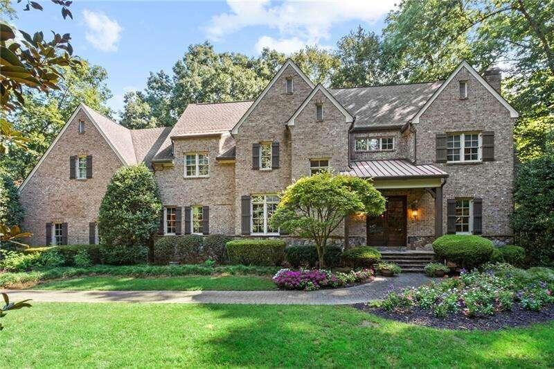 Stunning and stately Harrison-designed brick home is has a comfortable elegance on the inside. Built for entertaining and room to grow, each room is gracious in its style and details. The expansive entry foyer brings you to the living room with coffered ceilings, floor-to-ceiling windows allowing natural light to bathe the room during the day. The kitchen opens to the fireside keeping room with a raised hearth, built-ins and a wall of windows with French doors leading to the screened porch and expansive deck. A breakfast bar is the perfect place for a quick bite; butleras pantry; oversized island with vegetable sink and additional storage; all stainless kitchen; designer range hood adds another bit of elegance to the room. The separate, formal dining room adjoins the living room for a great flow. A wonderful surprise is an elevator serving all three levels. Voluminous owneras retreat featuring a fireplace, large sitting area, huge walk-in with custom built-ins, island with storage and large picture windows for the all-important natural light. Designer details include, hardwood floors, extensive millwork, high ceilings, multiple fireplaces and French doors. This generous floorplan offers a SECOND PRIMARY SUITE, landing with library, loft office and secondary bedrooms with ensuite bathrooms that exceed your expectations. The choice is yours with dual screen porches, the top one is located off the keeping room and kitchen, the lower level has a professionally maintained hot tub for year round use. The terrace level also offers additional living space at its finest! You could get used to thisa1 bedroom with a full bath; media room; bonus room; full bar; kegerator, ice maker, microwave, and beverage fridge. A serene location awaits on the stone patio with an outdoor fireplace, and large conversation area and grilling station. This lush setting is a wonderful place to make your own!