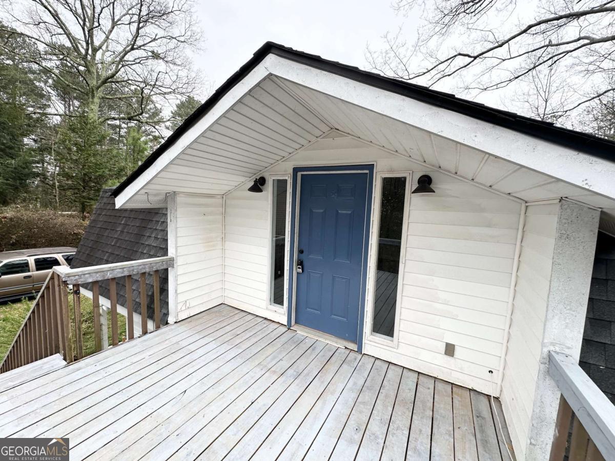 Welcome home to this beautifully updated 2-bedroom, 1-bathroom gem, perched on a private lot with serene views of a lake your peaceful retreat just minutes from the city. This inviting top-level unit of a duplex offers a bright, open floor plan that seamlessly connects the kitchen, dining, and living areas, creating the perfect space for entertaining or simply relaxing at home. Step inside to discover brand-new luxury vinyl plank flooring throughout, with sleek ceramic tile in the bathroom for a touch of modern style and easy maintenance. The kitchen boasts a functional layout with ample cabinetry, and just off the main living space, you'll find a stunning brand-new oversized deck ideal for grilling out, morning coffee, or simply soaking in the tranquility of the spacious backyard and picturesque lake views, especially in the fall and winter months. Enjoy the best of indoor-outdoor living with a large front and back yard offering plenty of room to roam, plus ample parking for you and your guests. Don't miss this rare opportunity for lakeside living in Mableton with both privacy and charm. Schedule your tour today and see what makes this home a standout!
