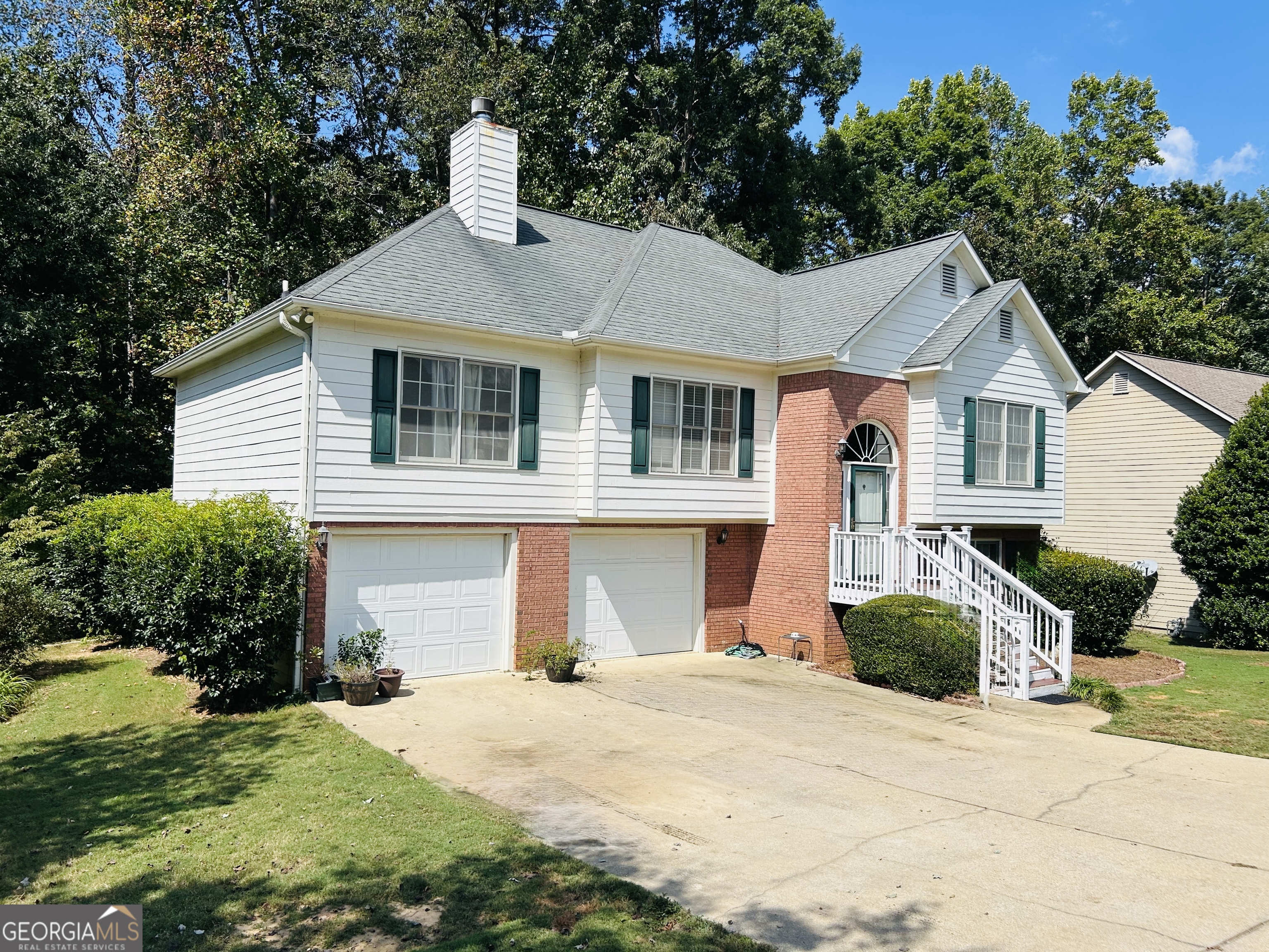 Welcome to 284 Legend Creek Lane in Douglasville, located in sought-after Paulding County! This spacious and well-maintained home offers over 2,300 sq ft of living space on a beautiful 1.38-acre property, giving you ample room for all your outside plans and activities! Inside, the home features 4 bedrooms and 3 full bathrooms, including a downstairs suite with a bonus room, bedroom, and full bath-ideal for guests. The primary suite is a true highlight with a walk-in shower, double sinks, and a whirlpool tub for spa-like comfort. The home also includes a formal dining room and a cozy fireplace. The kitchen is designed to impress, boasting granite countertops, ample custom cabinets, a built-in window seat, and above grade stainless steel appliances, including a 36-inch, six-burner gas oven and a Sub-Zero refrigerator-perfect for cooking and entertaining. Step outside to the deck overlooking your private backyard, providing the perfect setting for relaxing evenings or gatherings with friends and family. This property combines comfort, convenience, and scenic beauty-making it an exceptional place to call home.