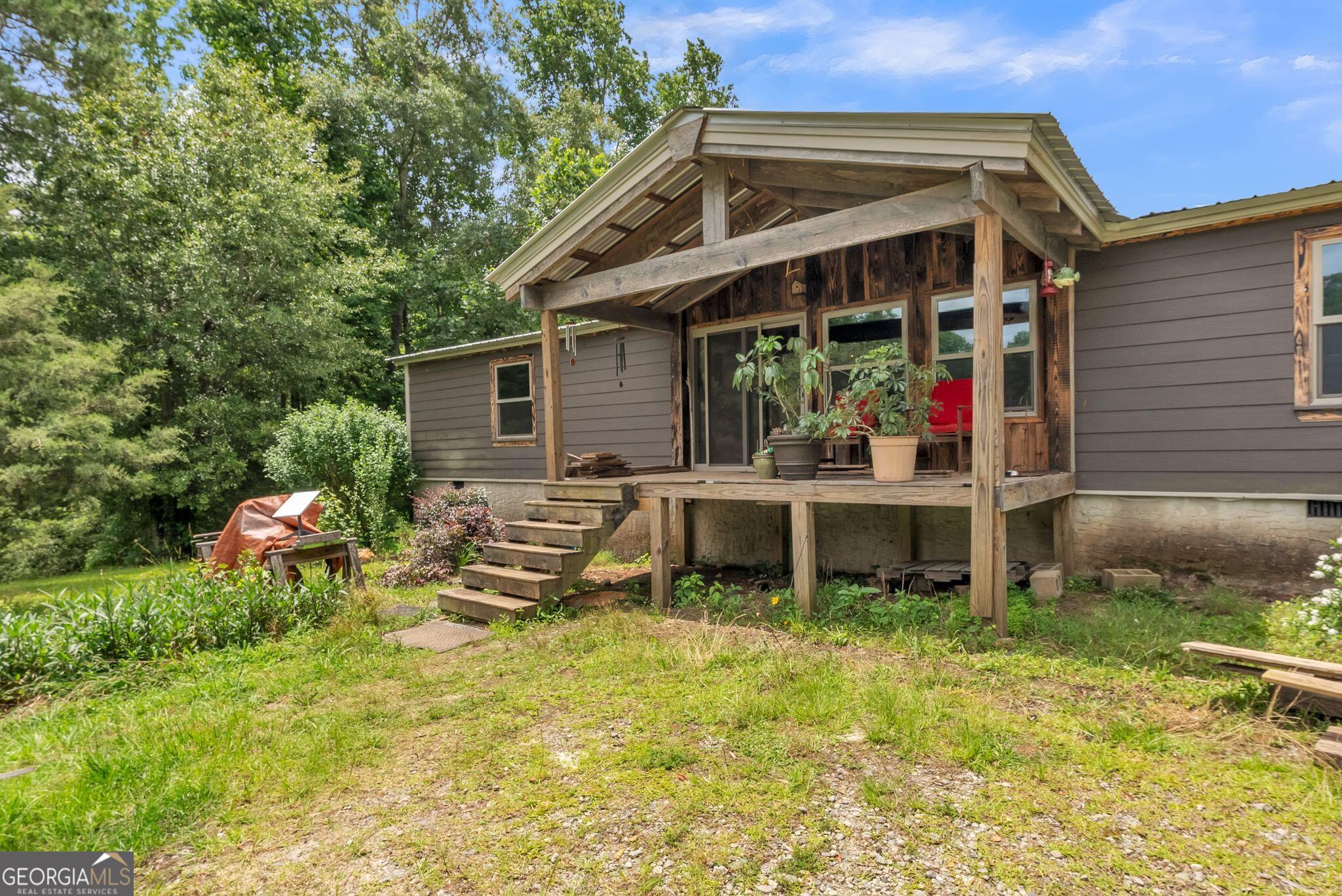 Discover the blend of space, privacy, and potential with this 3-bedroom, 2-bathroom home situated on 3.93 acres of peaceful land. With 1,620 square feet of living space, this property offers a comfortable layout that includes a spacious living area, a large kitchen with plenty of cabinet storage, and a dedicated dining area-ideal for both everyday living and entertaining. The primary suite includes a private bathroom, while two additional bedrooms and a second full bath provide room for family, guests, or a home office setup. Step outside and enjoy the possibilities that nearly 4 acres can offer-whether it's gardening, recreation, or future expansion. Located just minutes from downtown Jackson and High Falls Lake, this hom