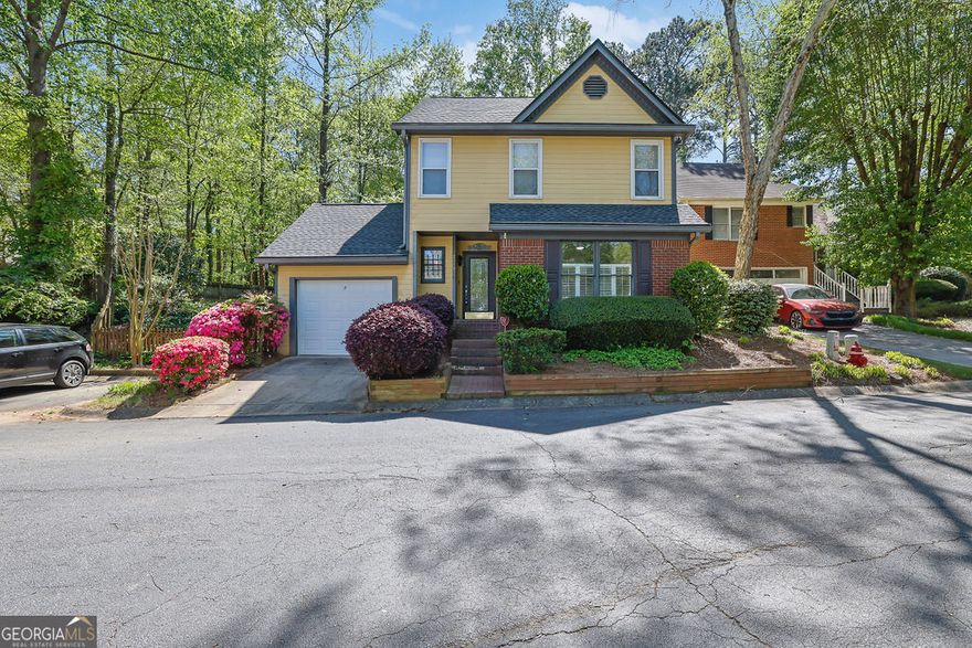 Welcome home to this charming cottage conveniently located close to Roswell, Alpharetta and Johns Creek. The landscaping is taken care of Front and back by the HOA. The backyard is stunning. You will think you have been transported to the English Countryside! This home is located at the back of the neighborhood in the cul de sac so plenty of parking for guests. The main level is open and airy and perfect for entertaining with a big kitchen and space for a dining area, family room and even an office nook. Upstairs, each of the three bedrooms are unique in their own style and the shared bath in the hall. The NEW HVAC was installed in 2023, a NEW ROOF installed in 2022,NEW  FLOORING 2023 on the main level of the home and NEW GARAGE DOOR in April 2025. Enjoy your morning coffee and your afternoon cocktail listening to the sounds of nature and gazing upon your gorgeous flowers. A MUST SEE!  Seller will provide $5000 Allowance for Paint/Upgrades.