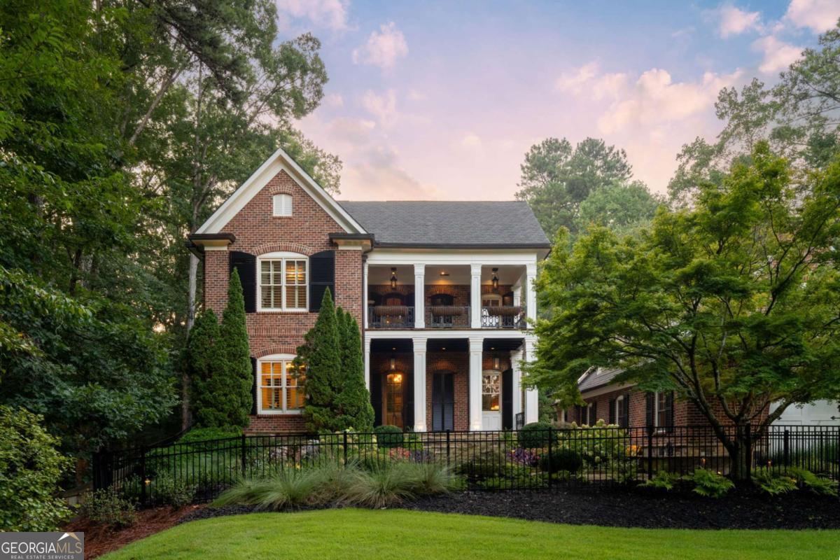 Welcome to this extraordinary custom-built estate situated on nearly 2 acres, just moments from the scenic walking trails of Kennesaw Mountain. Thoughtfully designed with luxury, functionality, and entertaining in mind, this home truly has it all.The heart of the home is the gourmet chef's kitchen, showcasing Thermador appliances, including a 6-burner commercial gas cooktop, double ovens, warming drawer, ice maker, Sub-Zero refrigerator, and a spacious island that seamlessly opens to the breakfast area and family room. Custom brickwork and rich cherry floors flow throughout the home, adding warmth and character. A large separate dining room offers the perfect space for hosting gatherings, while the family room centers around a stunning custom fireplace with built-ins. A light-filled sunroom overlooks the private backyard oasis, and a handsome study with built-in shelving provides the ideal work-from-home retreat.The primary suite on the main level is a true sanctuary with a spa-like bath featuring a clawfoot tub, separate shower, and an expansive walk-in closet. Upstairs, you'll find three generously sized bedrooms, each with walk-in closets with ensuite baths.The fully finished terrace level is designed for entertainment with a full entertainment system, pool table, and plenty of space for recreation.Step outside to an entertainer's dream backyard with a sparkling salt water pool, hot tub, pool house with full bath, outdoor kitchen, putting green, fire pit, and wooded privacy.Car enthusiasts will appreciate the three-car garage with a full apartment above, complete with a kitchen, living area, and bath-perfect for guests or extended family. Across the property, a separate two-car garage offers additional bays with lifts accomodating up to four cars and an upstairs office or storage space.This remarkable estate offers an unmatched lifestyle in a prime location. Don't miss the opportunity to make this one-of-a-kind property yours!