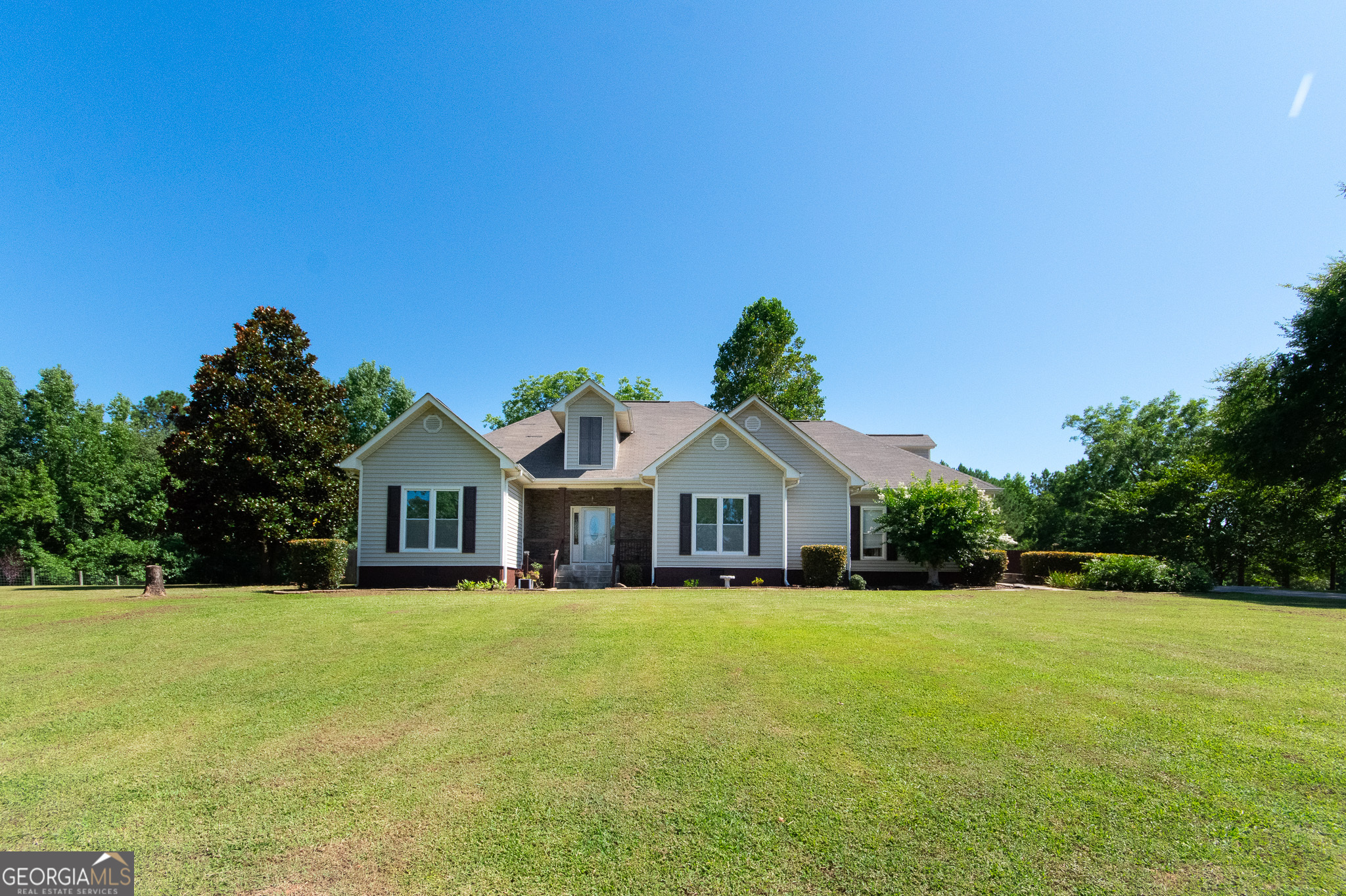Charming traditional ranch nestled on 3 picturesque acres! This 3 bed, 2.5 bath home features an open kitchen with breakfast nook, plus a separate formal dining room-perfect for entertaining. The spacious master suite offers trey ceilings, dual vanities, a walk-in closet, and a relaxing soaker tub. Upstairs bonus room provides flexible space for office, playroom, or guest retreat. Enjoy outdoor living with a screened-in back patio, custom stone fire pit, and two elegant concrete fountains. A thriving garden includes fruit trees, vegetables, and a versatile utility barn complete with kitchen-ideal for canning and hobbies. Peaceful, private, and full of charm!