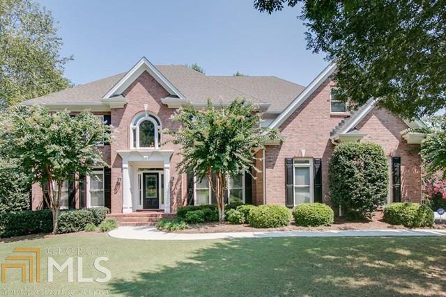 Once you see this house, you will want to call if home! Elegant 4 sided brick Executive home in swim/tennis community. Gourmet kitchen w/granite, SS appliances & plenty of space that opens to a 2 story great room. Great flow for entertaining. Main floor has spacious bedroom and full bath, large dining & living room (office). Amazing screened porch w/fireplace that overlooks professional landscaped backyard paradise. Master retreat has a fireplace, sitting area and a master closet with amazing built-ins. Finished terrace level has stacked stone fireplace,exercise room, full bath, private drive, garage & patio. The backyard is fenced and professionally landscapes with walking pathes and quaint nooks under the trees. Truely an amazing home to see!