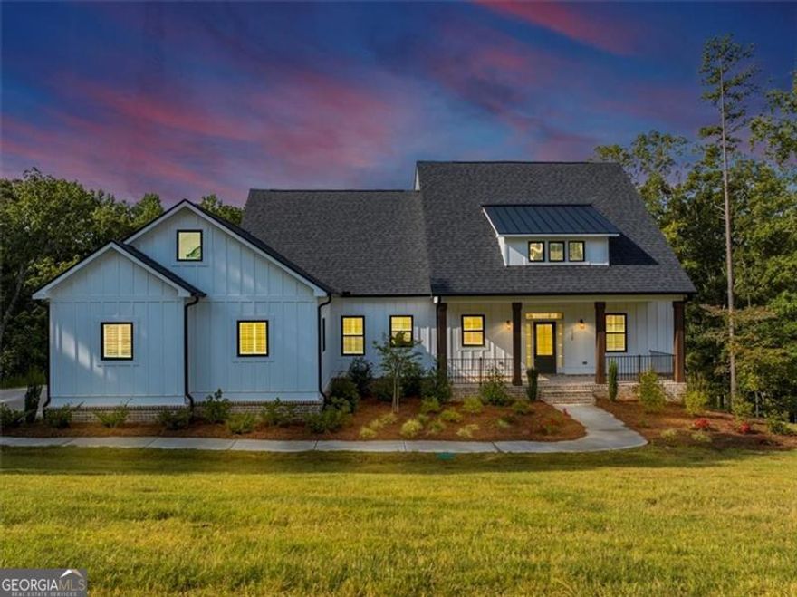 Welcome to 329 Oxford Road, an extraordinary Ball Ground estate where timeless sophistication meets modern indulgence. From the moment you arrive, the home's commanding presence and pristine architectural details set the stage for a lifestyle defined by elegance. Inside, soaring ceilings, expansive windows, and seamless designer finishes create a gallery-like ambiance. The chef's kitchen is a statement of luxury-appointed with custom cabinetry, professional-grade appliances, and a grand island perfect for elevated entertaining. Formal and casual living spaces flow effortlessly, each framed by meticulous craftsmanship and refined style. The owner's suite is a private retreat, offering a spa-inspired bath and boutique-style dressing area. Additional bedrooms and guest quarters echo the same uncompromising standard, providing comfort with distinction. Outdoors, sweeping grounds offer the perfect canvas for resort-style living-whether envisioning an infinity-edge pool, curated gardens, or grand-scale entertaining beneath the stars. Located in one of Ball Ground's most desirable enclaves, 329 Oxford Road is more than a residence-it's a showcase estate designed for those who demand the exceptional.