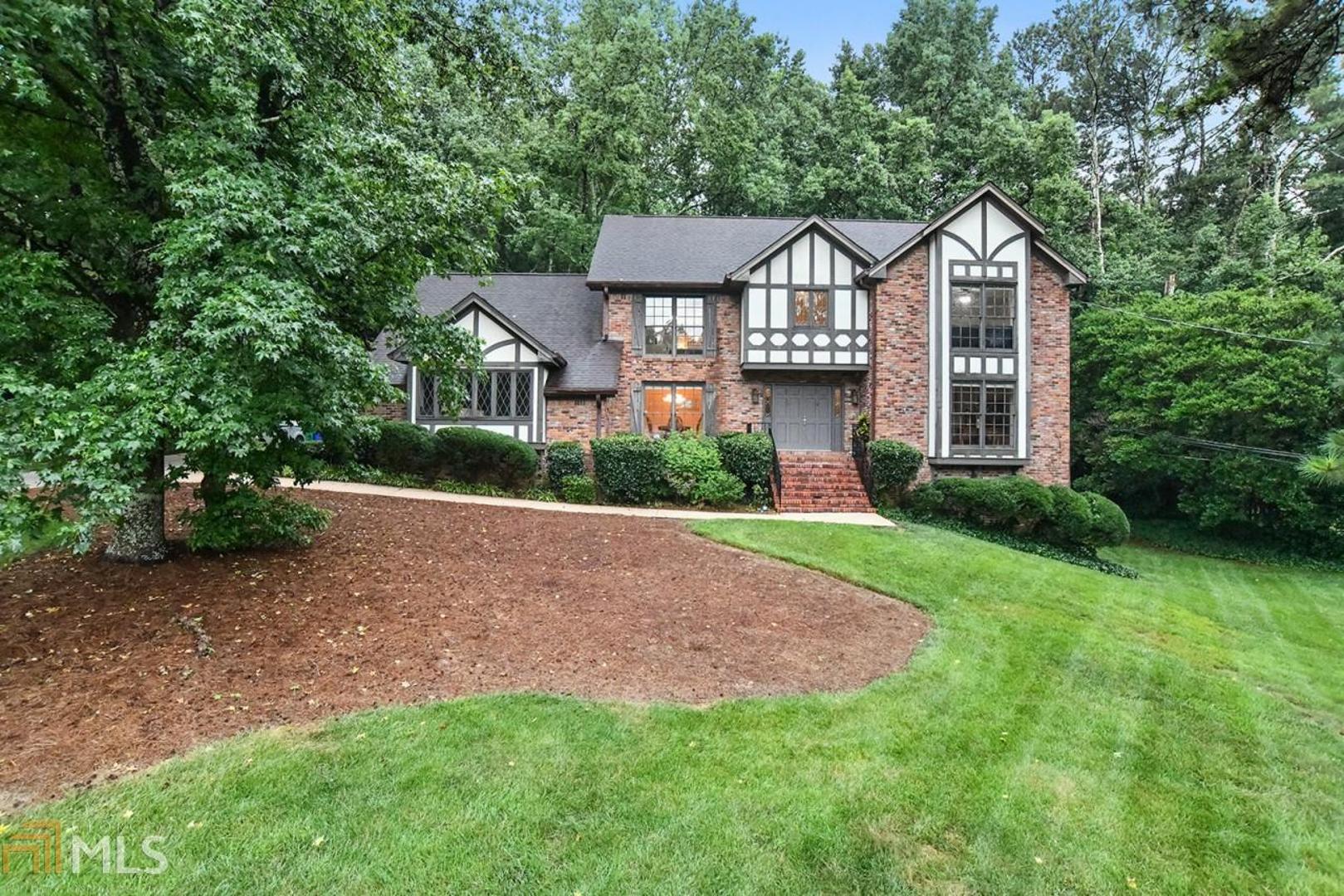 Spacious English Tudor Style home in sought after Smoke Rise Elementary. The impressive driveway & manicured lawns lead you to this delightful home. You are greeted with a two-story sweeping staircase with chandelier. A formal dining room, living room is also complimented by the cozy family room with fireplace, built-in shelving & Parkay wood floors. The large kitchen has under cabinet lights, Corian counters & boasts a double oven. There is a huge master bedroom and you can't say the bathroom doesn't have drama & style!