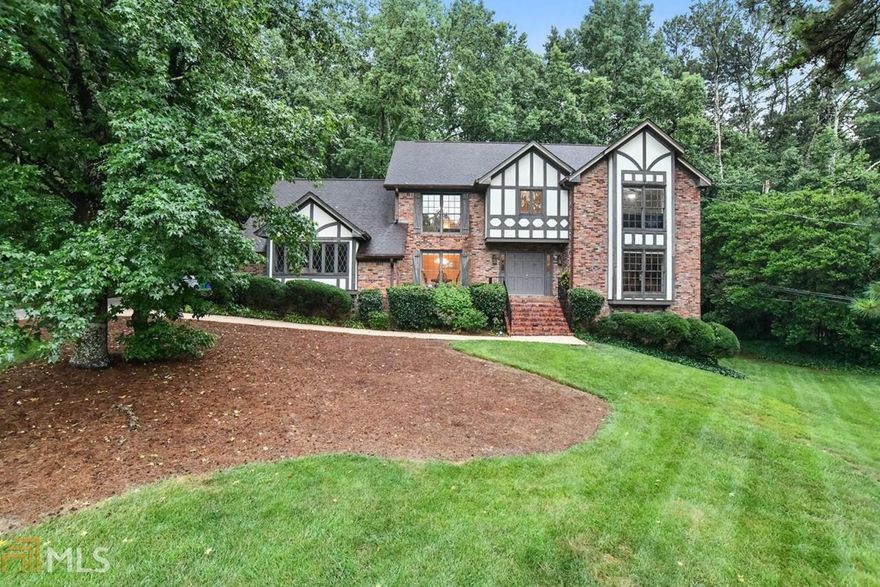 Spacious English Tudor Style home in sought after Smoke Rise Elementary. The impressive driveway & manicured lawns lead you to this delightful home. You are greeted with a two-story sweeping staircase with chandelier. A formal dining room, living room is also complimented by the cozy family room with fireplace, built-in shelving & Parkay wood floors. The large kitchen has under cabinet lights, Corian counters & boasts a double oven. There is a huge master bedroom and you can't say the bathroom doesn't have drama & style!