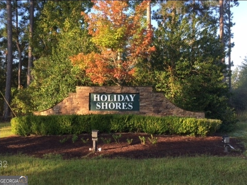 Welcome to Waters Edge area of Holiday Shores Subdivision on Lake Sinclair. Holiday Shores offers several amenities such as a Community Center with pickleball court, playground, pavilion, fire pit, floating docks and a boat ramp for easy lake access. Be sure to check out this level lot with close lake access and build your forever home.