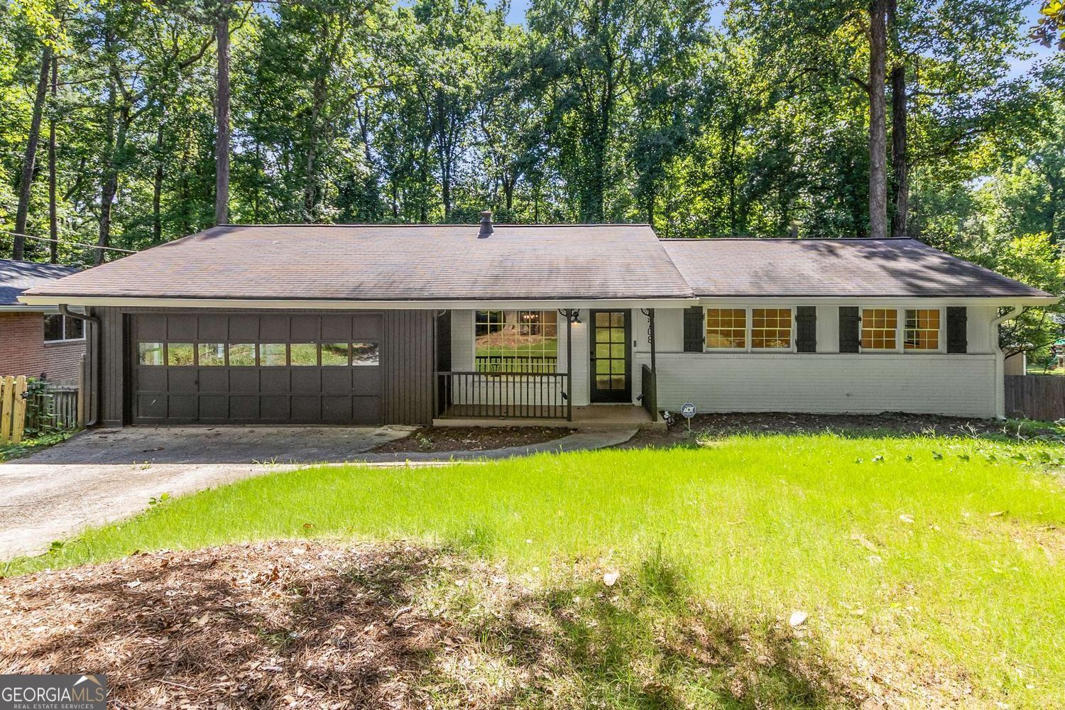 This beautifully renovated brick ranch in Montreal Woods offers a fantastic open and flowing floor plan with thoughtful design throughout. The spacious layout includes a private master suite wing with full ensuite bathroom, separated from the additional three bedrooms for added privacy. Enjoy a bright bonus sunroom that opens to a large back deck-perfect for entertaining or grilling. Inside, you'll find custom built-in shelving framing a cozy fireplace, fresh paint, and new floors. The fully renovated kitchen features new appliances, white cabinets, and granite countertops. Both bathrooms have been fully updated with stylish finishes. A large separate laundry room adds convenience, and the two-car garage provides plenty of storage. The open layout and well-defined spaces give this 2,311-square-foot home an even greater sense of size and comfort. Ideally located with convenient access to City of Tucker, City of Decatur, and Northlake, with quick access to Hwy 78, I-285, and Lawrenceville Hwy-this one checks every box!