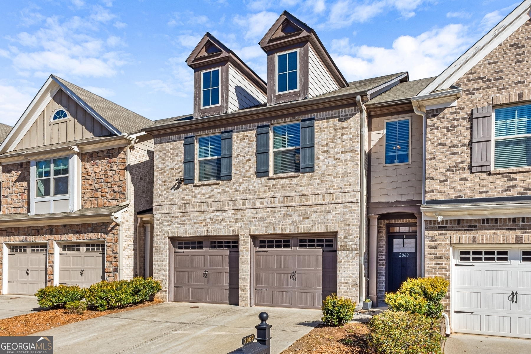 Price improvement - 1 year home warranty with accepted offer! Stunning 3-bedroom 2.5 bath Townhome in the desirable Caswell Overlook Community! Seller has invested thousands of dollars in quality upgrades for the home. Spacious open concept perfect for entertaining, with hardwood flooring throughout, no carpet! Seller replaced carpet upstairs with solid plank hardwoods and replaced linoleum floors in second bathroom and laundry room with tile. High coffered ceilings in the great room along with built-in shelves, and gas log fireplace with new custom fireplace surround. Kitchen features granite counters, island, new stove, dishwasher, and garbage disposal installed in 2022. Dining room features new chandelier. Almost all lighting throughout the house has been upgraded from builder's grade. You can also enjoy being outside with your private, fenced patio with raised garden beds. Upstairs, there is a huge loft/ flex space. Seller installed a ceiling outlet with a shelf to use a projector and turn the space into a movie room! Oversized master suite with tray ceilings, and luxurious master bath with soaking tub, dual vanities, and custom walk-in closet makes for a nice retreat. Two additional bedrooms, a full bath and convenient full sized laundry room round out the upstairs space. Two car garage with automatic door openers. HOA includes water, trash, yard maintenance, pool, and playground. Fantastic location minutes from The Battery, Truist Park, Comet Trail and easy access to I-75 and I-285.