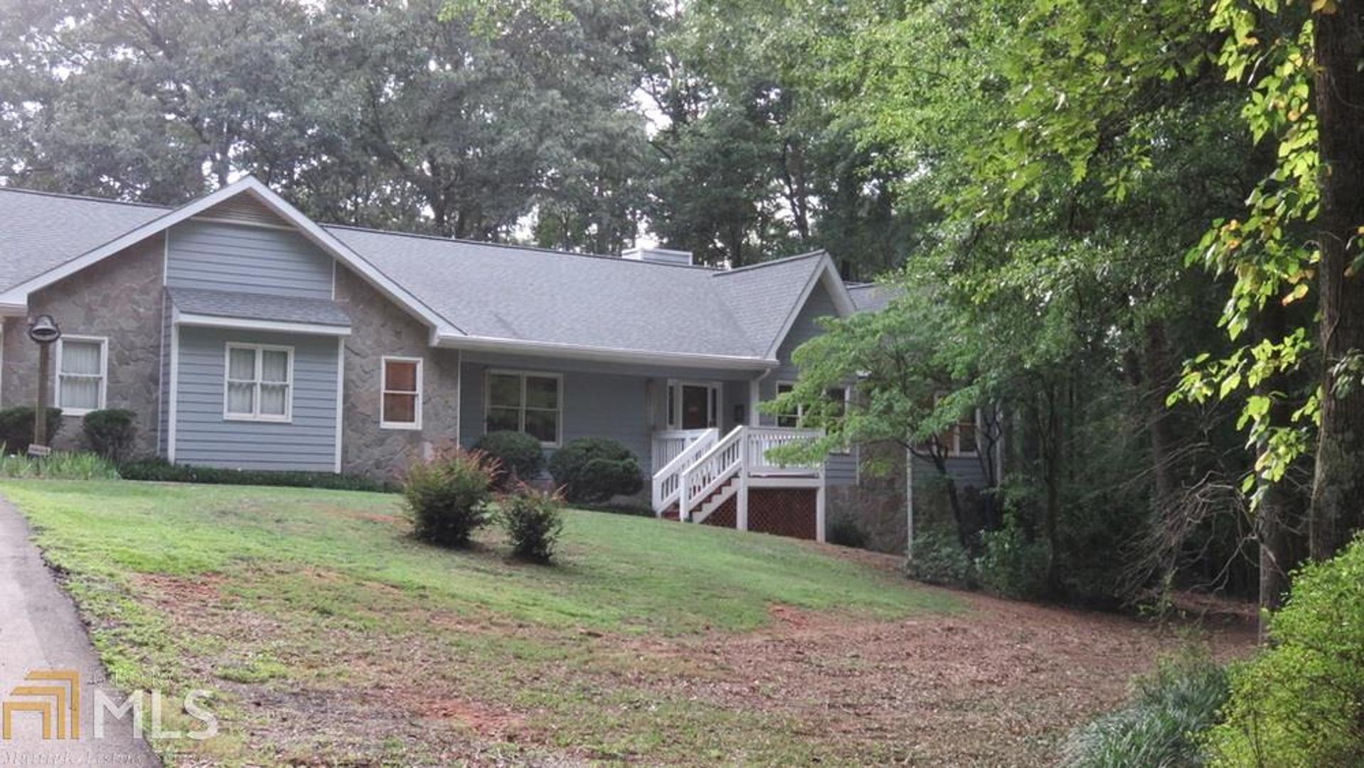 Close-in, country living. Winding driveway through the woods leads you to a 3BR/3BA ranch on full basement on 3.22 acres, in convenient Kelleytown/McDonough location. Meticulously maintained, one-owner home with wood floors and plenty of entertainment space. Large kitchen with island and stained cabinetry. Huge bedrooms and lots of living area. Sitting area leads from kitchen to huge sun room. Warm and inviting living room with stone fireplace. Attic fan for Spring and Fall, and central heating and air for the Winter and Summer. Over sized garage with storage room. Basement has 3 large, finished rooms and a huge workshop area with a boat door. You've got to see this beautiful home!
