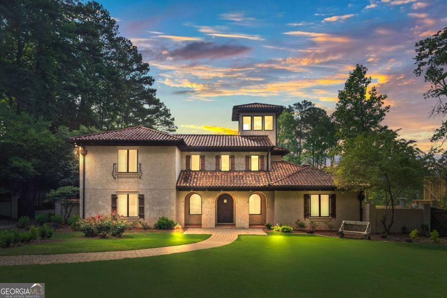 Welcome to a residence steeped in cinematic history. Located in the most prestigious area of Marietta on Woodlawn Road near Paper Mill, this luxurious gated property is truly one-of-a-kind with authentic Mediterranean Architecture and details throughout the entire home with over an acre to enjoy. It came to serve as the backdrop for the acclaimed TV series Cobra Kai after being built due to its unique characteristics and details that you will not find anywhere else. Enter through a grand two-story foyer into a spacious living area ideal for relaxation and entertaining. The center of the home is a two-story Indoor Atrium with a waterfall, walkway and large windows that connect all areas of the home. The Atrium has the most peaceful sounds with stunning design that will captivate your senses and provide natural light throughout all areas of the home. The gourmet kitchen features top-of-the-line Wolf appliances and custom cabinetry, perfect for culinary creativity. The wood burning stove is the ideal spot for pizza night. The details are fascinating! The windows above the Kitchen sink slide open to view the outdoor covered patio with beautiful two-sided fireplace where you can pass dishes or have guests sit at the bar area.  Once outside, enjoy lush landscaping, an expansive patio, a greenhouse, a sparkling heated pool and spa, as well as multiple outdoor grilling areas. If you enjoy gardening, you will appreciate the fruit trees, the sectioned off vegetable areas and open yard space.  The owner's suite on the main floor has a large fireplace, spacious sitting area, French doors to the covered patio and a large walk-in closet. The owner's bath is the most spectacular bath you will find as you can step into your pool from the bath area. The large shower features dual shower heads and a level of creativity you have to see to believe. All secondary bedrooms feature ensuite baths and walk-in closets. There is a laundry room on each floor for convenience. There is an office on the main floor tucked away for privacy. Whether you're a fan of Cobra Kai or seeking a home with a rich backstory, this property combines luxury, history, and prestige. You cannot find anything like this incredible home in Atlanta and you will not want to miss it. Schedule your private showing today and experience this iconic residence firsthand.