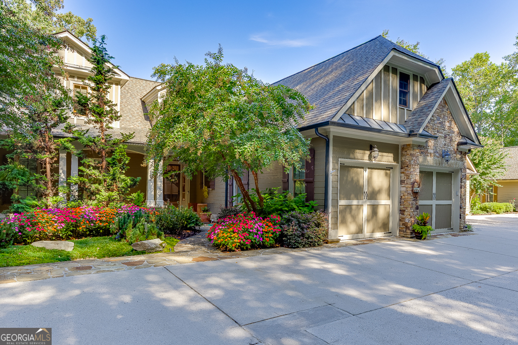 Discover luxury living beyond the greens in this beautifully updated 3-bedroom, 3.5-bath villa located on prestigious Hole #1 of Achasta's Jack Nicklaus Signature Golf Course. With 3,311 sq. ft. of thoughtfully designed space across three levels - plus additional unfinished square footage in the basement and upper level for future expansion - this home blends comfort, style, and flexibility. Inside, you'll find 10-ft ceilings, and elegant 8-ft doors, custom Pella windows with built-in blinds, beamed accents, and built-in bookcases in the loft and media room. The back of the home is lined with endless windows, gleaming hardwood floors, filling the space with natural light and framing beautiful golf course and mountain views from nearly every room. The main-level primary suite offers a spa-like bath with jetted tub and separate shower, coffered ceiling, and large walk-in closet. The chef's kitchen features a five-burner gas cooktop, stone counters, walk-in pantry, and breakfast bar opening to the fireside family room and sunroom. The terrace level boasts a media room, wet bar with ice maker and mini fridge, and abundant storage. Step outside to your covered patio with cypress wood ceiling, speakers, Big Green Egg, and hot tub, all overlooking professional landscaping with irrigation, raised garden beds, and private stairs leading directly to the golf course. Recent upgrades include a new HVAC (2022), roof (2019), water heater (2021), expanded laundry room, fresh exterior paint (2021), and soft wash in 2025 - meaning this home is move-in ready and worry-free. Additional highlights include an extra-wide parking space designed to accommodate a golf cart, with the golf cart itself included in the sale. A custom wine rack will also remain with the home, offering both functionality and charm. But life in Achasta is about more than a home - it's about a lifestyle. Enjoy a vibrant, gated community with an endless array of amenities: four newly resurfaced tennis courts, pickleball courts, a resort-style pool with tiki bar, 3.5 miles of walking trails, River Park with river access for fishing and kayaking, and a clubhouse with restaurant and social events. Plus, Dahlonega's award-winning wineries and tasting rooms are just minutes away. Every day here is an invitation to explore, relax, and connect with nature - all less than 60 minutes from Atlanta.