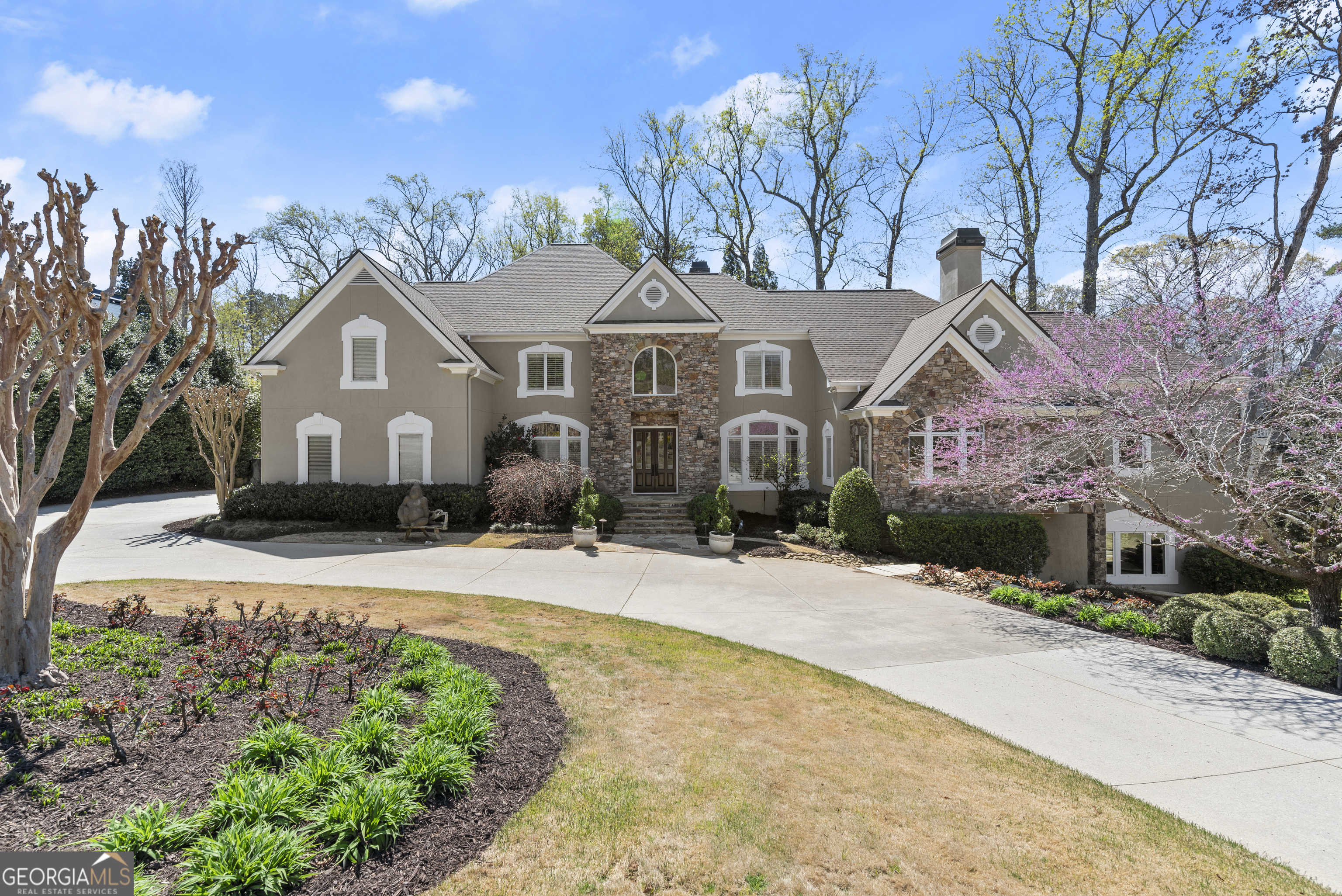 Don't miss this exceptional opportunity to own a stunning estate in the highly sought-after Atlanta Country Club, just a short walk from the club and McFarland Park. Designed for both everyday comfort and grand entertaining, this exquisite home features a walk-out main level saltwater pool, a cascading waterfall spa, and a beautifully finished daylight terrace level complete with a media area, temperature-controlled wine cellar, expansive recreation room, and full bar with stunning quartz countertops, a refrigerator, sink, ice maker, and dishwasher. This stunning home boasts an open, inviting layout perfect for large families and guests. The chefCOs kitchen is a masterpiece, featuring white cabinetry, a spacious island, a walk-in pantry, new quartz countertops, a Sub-Zero refrigerator, and top-tier stainless steel appliances. Overlooking the private pool and spa, the keeping room and kitchen seamlessly blend indoor and outdoor living. Recent enhancements include new hardwood floors in the kitchen and entryway, a new grilling deck and screened porch with high end trex decking, and terrace-level patio, expanding outdoor entertaining possibilities. The banquet-sized dining room comfortably seats 12 or more, making it ideal for hosting unforgettable gatherings. The main-level OwnerCOs Suite is a private sanctuary, featuring a marble fireplace, a cozy sitting area with a custom vaulted ceiling, a spa-like bath with a steam shower and soaking tub, custom His & Hers closets, and a private laundry room. Upstairs, a second primary suite with a newly remodeled bath (completed this week) is accompanied by three additional bedrooms, three full baths, and a versatile bonus/playroom/office. The newly finished sixth bedroom on the terrace level includes a walk-in closet and access to a full bath. Additional features include two large offices on the main level, a new roof installed in 2023, fresh interior paint in 2024, and exterior paint updated in 2021. A whole-house water filtration system ensures premium water quality, while three gas fireplaces add warmth and character. The home offers abundant storage throughout, including oversized walk-in closets, and a second laundry room upstairs for added convenience. Situated on a .71-acre lot with professional landscaping, this home provides ample space and privacy. Located on the club side of the neighborhood, where power lines are buried to reduce outages, it is also zoned for top-rated Sope Creek Elementary, Dickerson Middle, and Walton High School. A rare opportunity to own a home that blends luxury, comfort, and an unbeatable locationCoschedule your private tour today!