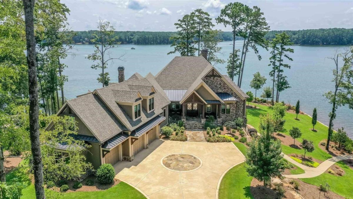 "YOUR PRIVATE PENINSULA AT HORSESHOE BEND IN REYNOLDS! STUNNING HOME WITH AMAZING VIEWS FROM NEARLY EVERY ROOM OF THIS IMMACULATE HOME WITH 500 FT OF WATER FRONTAGE" Imagine yourself waking up to the most spectacular views of Lake Oconee every day! Finished in 2019, this 6,700+  sq ft, five bedroom, five and a half bath showstopper is packed with luxurious features. No detail was overlooked nor expense spared during the construction of this beautiful home that sits on 1.10 acre of level lake property with 500 ft of water frontage. The beautiful long private driveway takes  to your own oasis with water views as far as your eyes can see to your left and right. Upon entering the foyer, you are greeted by a gracious open floor plan with water everywhere. The Chef's kitchen features a big island with 8-seat bar, equipped with high end appliances - Wolf double steam oven, Wolf cooktop, Bosch dishwasher. The main level features reclaimed pinewood floors. The expansive great room with fireplace is open to the kitchen, dining room and adjacent to a gorgeous porch overlooking the lake. Just off the Master Bedroom is one of two laundry rooms with the other being on the terrace level. Need to work from home? There is an oversized guest bedroom that has currently been converted into a spacious office space. Step out onto the tiled screened porch for your morning coffee next to the wood-burning fireplace or have guests over for a football game and cookout on the adjoining grill deck complete with your own grilling kitchen- ceramic grill, two-burner cooktop and beverage refrigerator. The Master Suite offers breathtaking views of the lake, with luxury master bath and large his and hers closets. Take the elevator down to the lower level to your family room with adjacent game room and wet bar/kitchenette. Two additional bedroom suites are located on the terrace level. The terrace level patio is perfect for entertaining with a hot tub and fire pit, lakeside. Stroll across the level lot to the max dock with two boat lifts to spend a day on the lake. After a fantastic day out on the lake, retire to the third floor in-law suite via elevator -above the three car attached garage. This property is ideally located within short boating distance to the Richland Pointe, Ritz Carlton and Lakeclub.This is a rare and special property at Reynolds Lake Oconee. Club Membership is available.