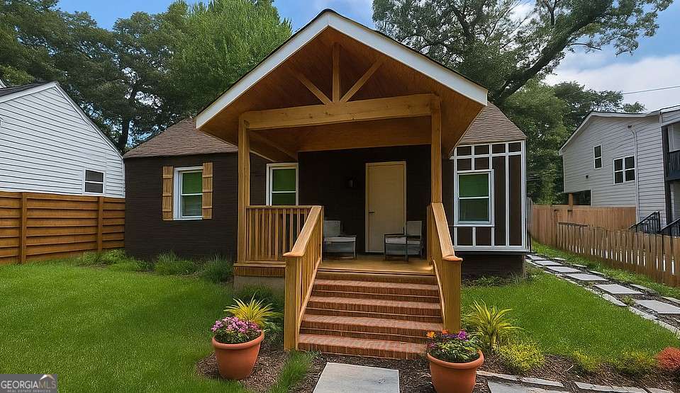 Discover this fantastic value in the heart of Lakewood, offering quick access to major freeways, downtown Atlanta, parks, and the Atlanta Beltline. A welcoming rocking-chair front porch sets the tone, leading you into an open-concept layout with a spacious living room and a separate dining area. High ceilings and abundant natural light create the perfect atmosphere for entertaining family and friends. The oversized primary suite is a true retreat, featuring dual granite vanities with elegant gold fixtures, a walk-in shower with custom tile and double shower heads, and a large walk-in closet designed to fit your wardrobe with ease. Two additional guest bedrooms share a beautifully updated bath with marble tile and a European-style tub/shower combination. Recent updates include new LVP flooring, fresh interior paint, a new roof, new windows, and a new water heater-providing peace of mind and a solid foundation. The home does require some finishing touches: the kitchen needs additional cabinets, counters, and appliances, while the bathroom will need final completion. With nearby homes demonstrating strong values, this property presents a unique opportunity to build instant equity with a little TLC. It's an ideal candidate for a small renovation loan (not eligible for FHA or VA), allowing you to personalize and complete the home to your style. Don't miss out on this incredible investment and lifestyle opportunity! Note: Photos have been virtually staged and enhanced with AI.