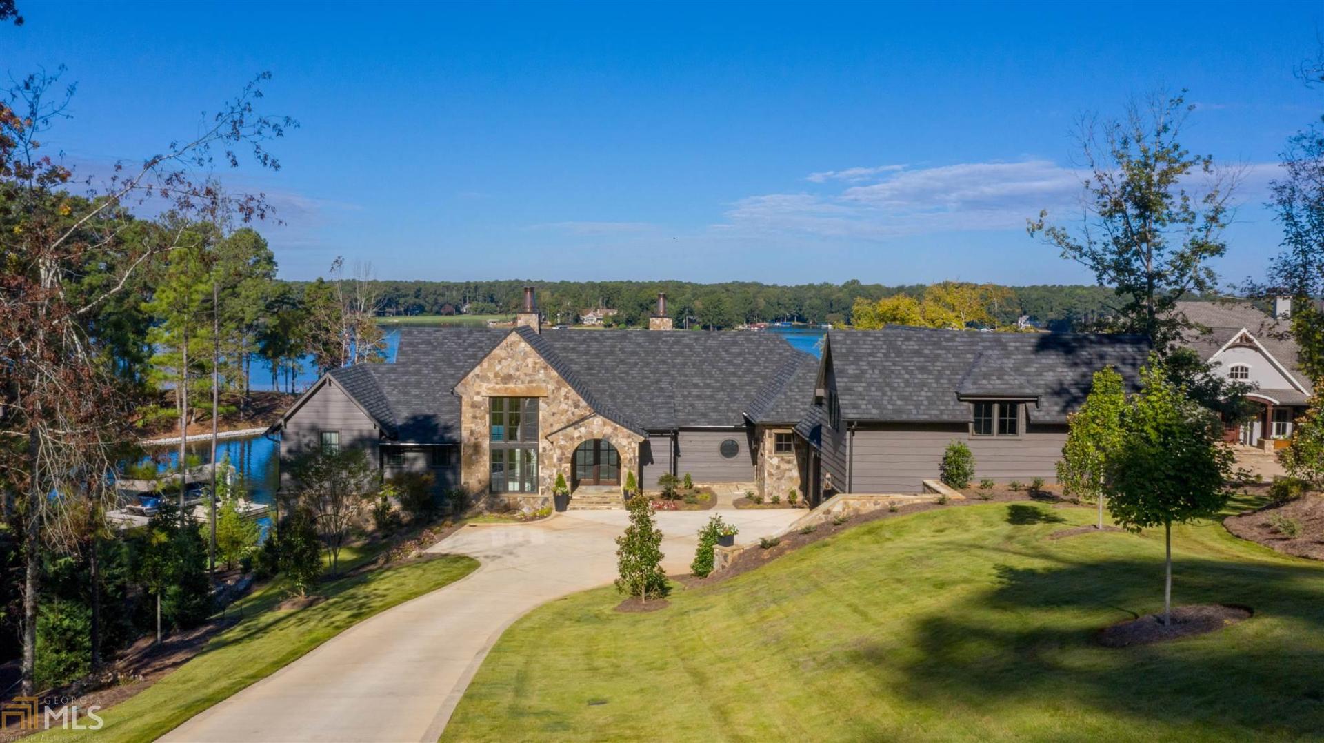 "QUINTESSENTIAL CUSTOM LAKE HOME, NEWLY-BUILT AT HORSESHOE BEND OF REYNOLDS LAKE OCONEE WITH ENDLESS DETAILS, MAGNIFICENT VIEWS AND IDEAL LOCATION" This is your private lake paradise! The brand new 6,400+ sq ft stunning home was designed by renowned architect Brad Wright of Wright Designs LLC, offering superb craftsmanship throughout the home that features: wavy pine siding, stack stone, Pennsylvania bluestone pavers, timber frame porches, tongue and groove cypress floors and ceilings, custom iron windows, copper chimney pots, European French oak floors, custom iron railings, custom cabinets by Morgan Creek, makers of fine handcrafted cabinetry, quartzite counters throughout, marble tiles in the master bath and more. The 5 bedroom, 5 bath and 2 half bath home features a Chef's kitchen with Wolf and Subzero appliances, custom reclaimed oak island top. Outdoor kitchen features Wolf grill with rotisserie and phenomenal lake view dining area. There are three masonry fireplaces including a limestone fireplace in the great room. The steel case glass doors brings the outdoors in, offering the best front row lakeview seat from the spacious screened porch. The lower level family and game room take you out to the fantastic pool with tanning ledge, built-in seating and retractable cover. There is a custom wine cellar, outdoor shower, a lake locker room with ice maker and refrigerator, and a lower level cart garage with storage and key pad entry. There are three spacious suites with private baths in the terrace level. The max dock with built-in steps is perfect for a 7,000 lb boat and jet ski. This fabulous lake home offers an oversized three-car garage, a central vac with 11 inlets, 5 HVAC zones with 14 & 16 seer system, irrigation via lake pump, and upper and lower level laundry room. It is the ultimate lake paradise you've been waiting for. Reynolds Club Membership option is available.