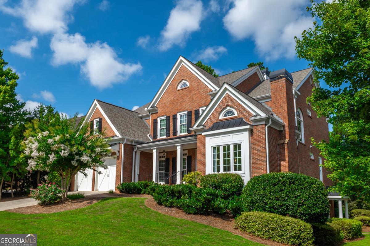 Video Link: https://youtu.be/M70a0a_rLTY Nestled in a prestigious enclave surrounded by top-tier private schools and an acclaimed magnet high school, this east-facing, 4 sided brick masterpiece offers an unparalleled blend of elegance and extraordinary value. This meticulously updated residence is a rare opportunity to secure a luxurious lifestyle at an exceptional price in a highly coveted golf cart community. Freshly painted with new windows, brand new appliances, new HVAC, 3.5 year old roof, this home radiates sophistication and effortless living. Step into a breathtaking two-story living room, where a dazzling chandelier illuminates soaring cathedral ceilings, custom built-in bookcases, a gas fireplace, and floor-to-ceiling windows that bathe the space in natural light. The gourmet chef's kitchen, a culinary haven, features gleaming granite counters, stainless steel appliances-including double ovens- a breakfast bar, and an inviting breakfast room. A refined office with a fireplace and French doors, a versatile computer room with a built-in desk, a spacious bedroom, and a generously sized laundry room (complete with washer and dryer) complete this level's seamless fusion of function and style. Ascend to the re-stained hardwood floors of the upper level, where the oversized primary suite awaits as a private retreat. Indulge in a spa-inspired bathroom with a large shower, jetted tub, double vanities, and a cavernous closet, all beaming with glorious natural light. Two additional bedrooms, each with ensuite bathrooms, offer privacy and comfort for family or guests. The fully finished basement, accessible via a private ground-floor entrance, is a world of its own. A full kitchen with new appliances and a dryer hookup anchors this space, complemented by a cozy den, two bedrooms, and a recreation room complete with a pool table-an ideal setting for entertaining or multigenerational living. Outside, a screened-in patio flows effortlessly from the kitchen to a sprawling deck, with a shaded patio below, perfect for al fresco gatherings. The expansive, irrigated lot, framed by a serene tree-lined backyard, offers ample space for a pool or custom outdoor retreat, inviting endless possibilities. Residents enjoy access to an exclusive neighborhood clubhouse featuring a pool with a waterslide, tennis courts with a pavilion, a playground, and an 18-hole golf course. With trash pickup included, this vibrant community elevates convenience and leisure to new heights. This home is being offered at an unmatched value for the most discerning buyers who seek timeless luxury and a solid investment opportunity.