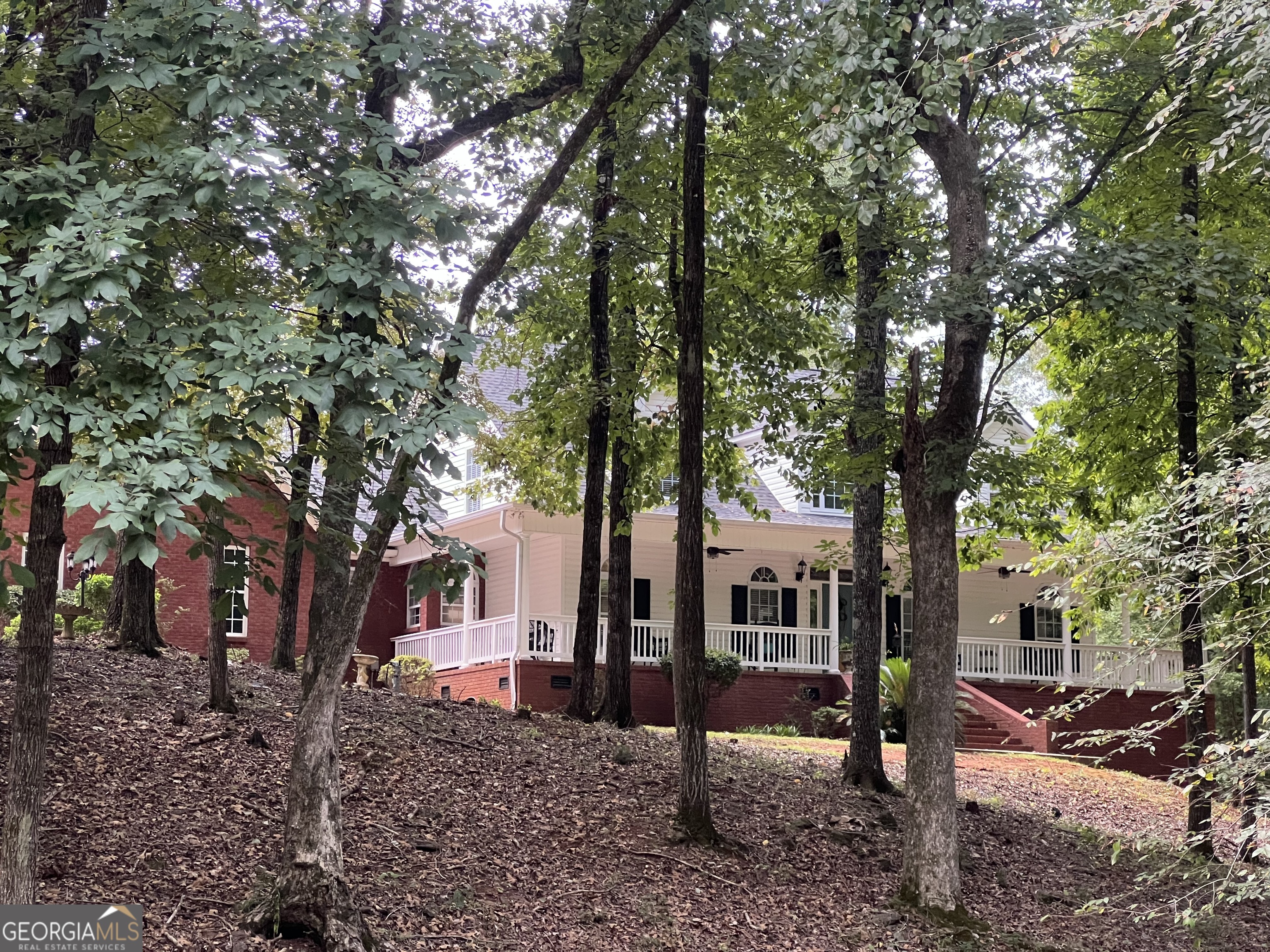 New on the market! Amazing 4 bedroom, 3 bath brick/vinyl siding home located in Daybreak Estates on Green Oak Circle! Downstairs Features large kitchen with custom-build cabinets, convenient bar, breakfast room which opens to a 2-story great room with fireplace and gas logs. Foyer is separated with large columns and marble flooring and a separate dining room. Master bedroom is opened to a lovely bath with garden tub, separate shower, 2 separate vanities and 2 separate walk-in closets. Plenty of room for two getting dressed for the early morning work day. Second bedroom was actually used as a study. Perfect for an office. Private entrance! Lots of crown molding hardwood floors, tile in baths, marble in foyer. Upstairs features 2 bedrooms, 1 bath, large catwalk which makes a lovely reading area. Pool room/bonus room with separate stair way, small room between bedroom and pool room/bonus room which could actually be another bedroom, playroom or study. Between bedrooms is lovely reading area or upstairs study. Upstairs has been freshly painted and new carpeting. Tile in bath. Home also has a new roof. Large screened porch and big wrap around porch with rails, perfect for those autumn evenings coming in. Double garage with 2 storage rooms. Lots of privacy, at end of road within 3 miles of the city. Close to the hospital. Approx. 4.2 wooded acres, branch on property. Beautiful view and lovely fall scenery. Come take a visit of this lovely home today. Owner downsizing. *** Total square footage upstairs/downstairs is approx. 3400 square feet.